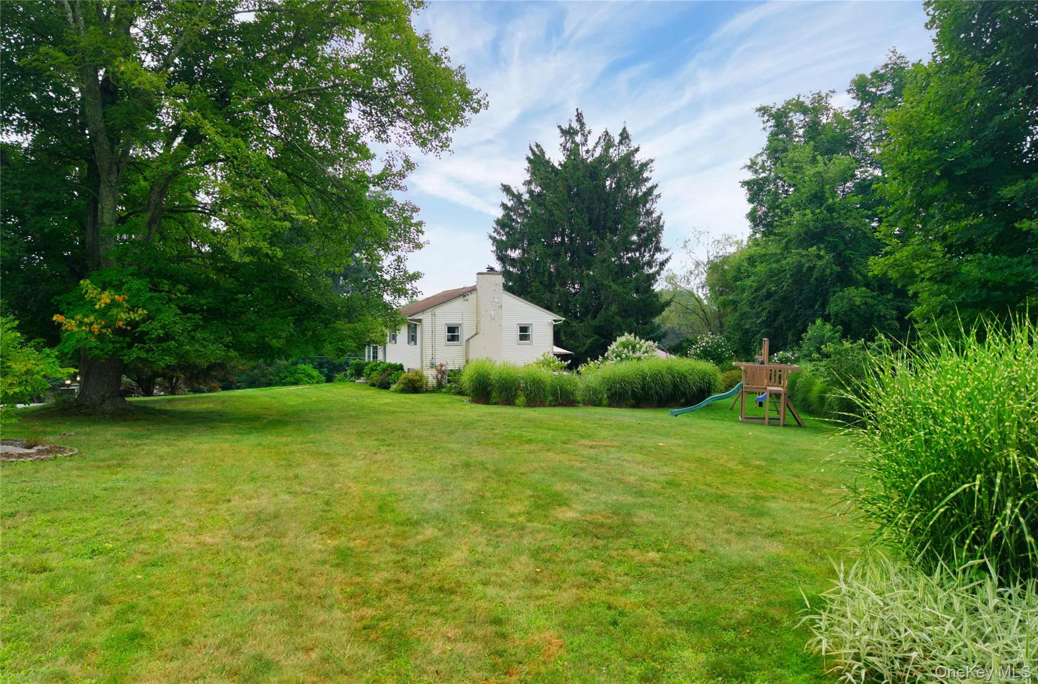 Large level yard with beautiful landscaping. Large level yard with beautiful landscaping.