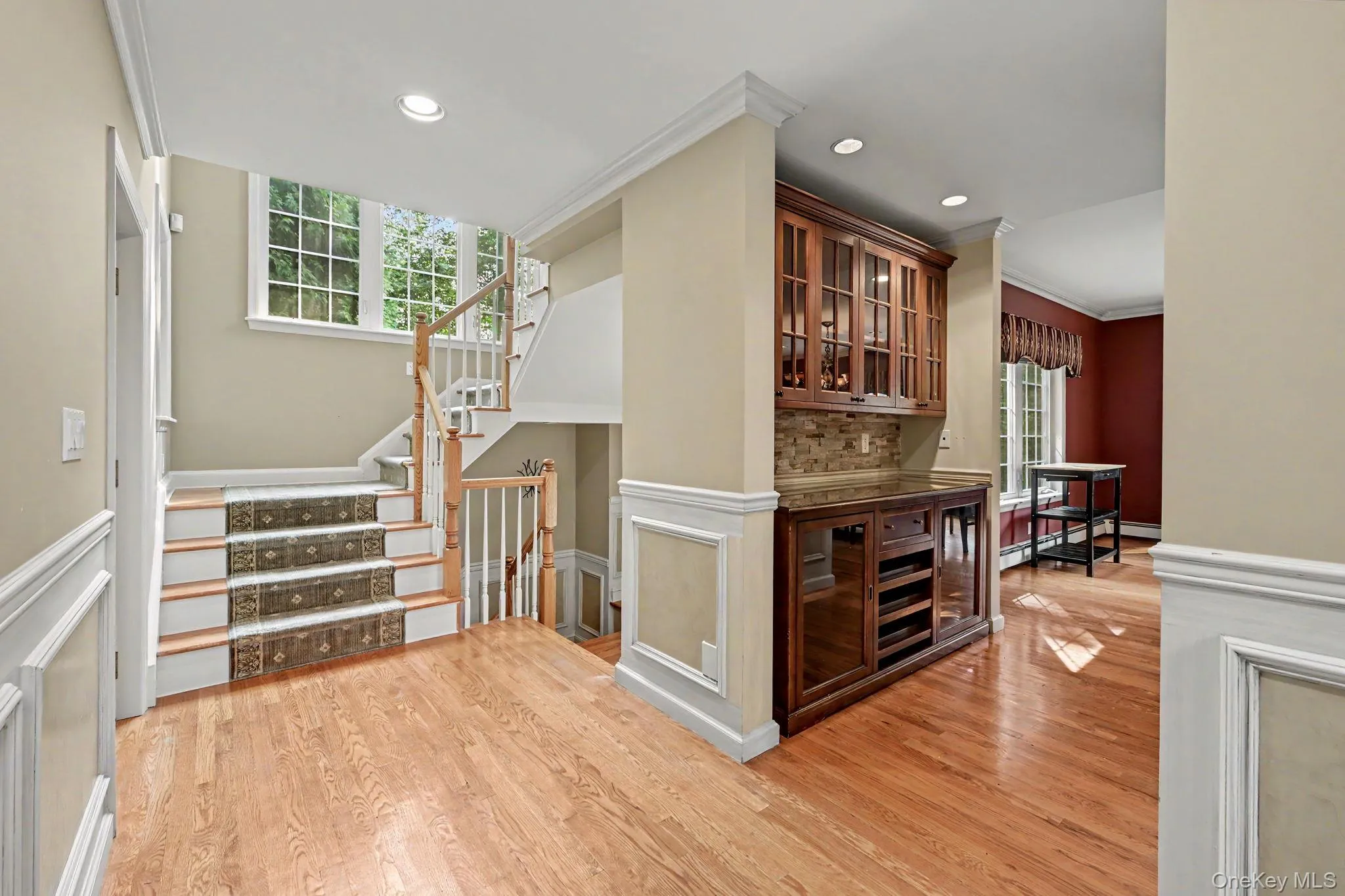 Entry foyer with view of butler's pantry, stairs to 2nd floor and kitchen on left. Entry foyer with view of butler's pantry, stairs to 2nd floor and kitchen on left.