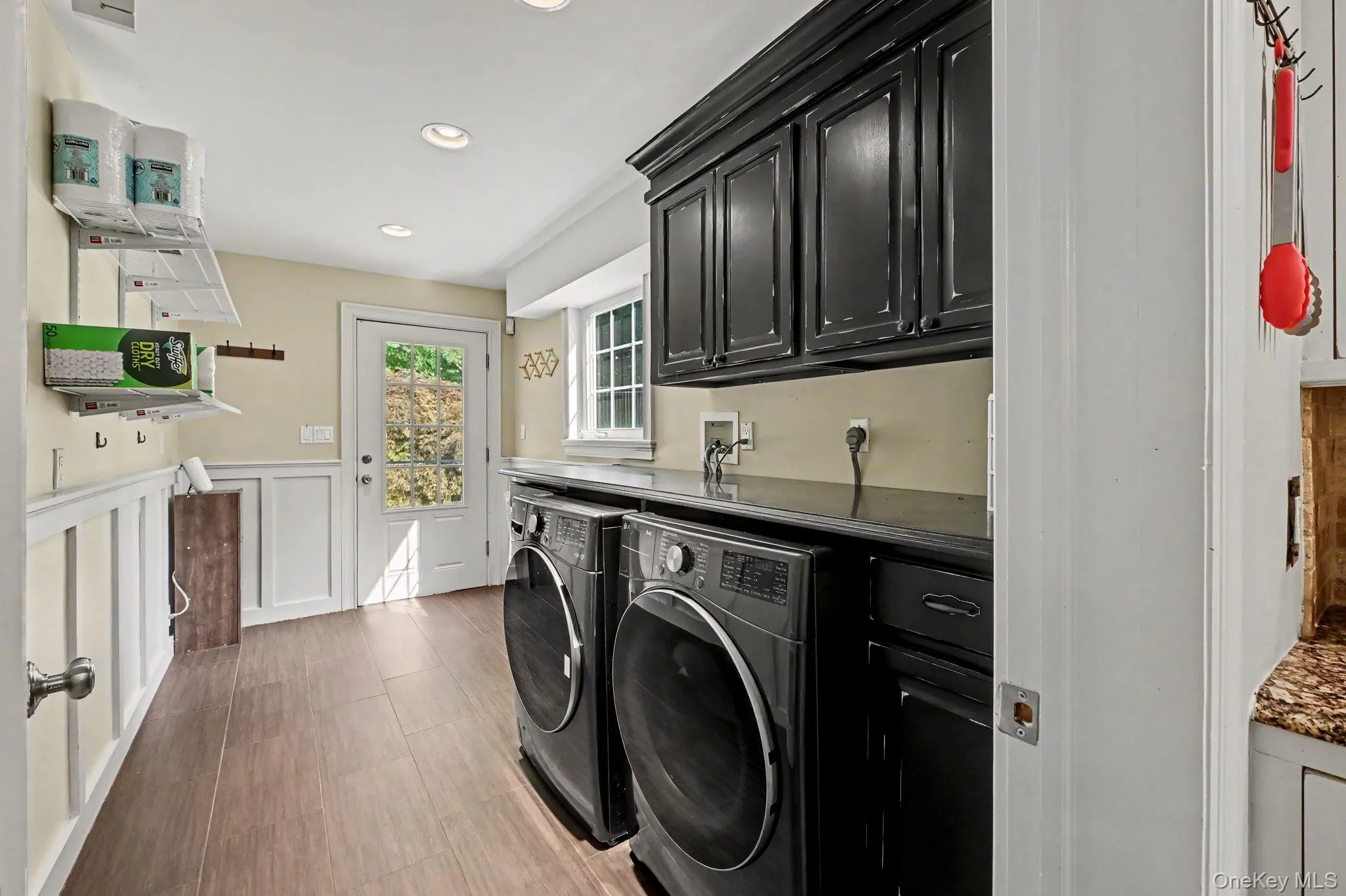 A well-appointed laundry room with door to back patio. A well-appointed laundry room with door to back patio.