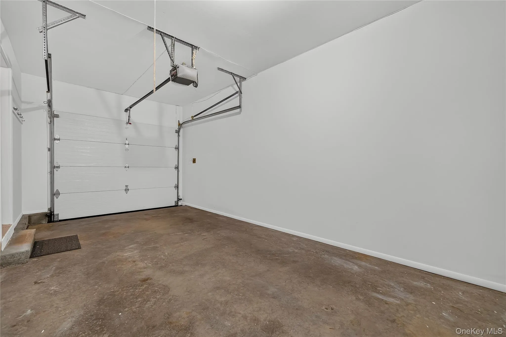One car garage with storage space and utilities in closet One car garage with storage space and utilities in closet