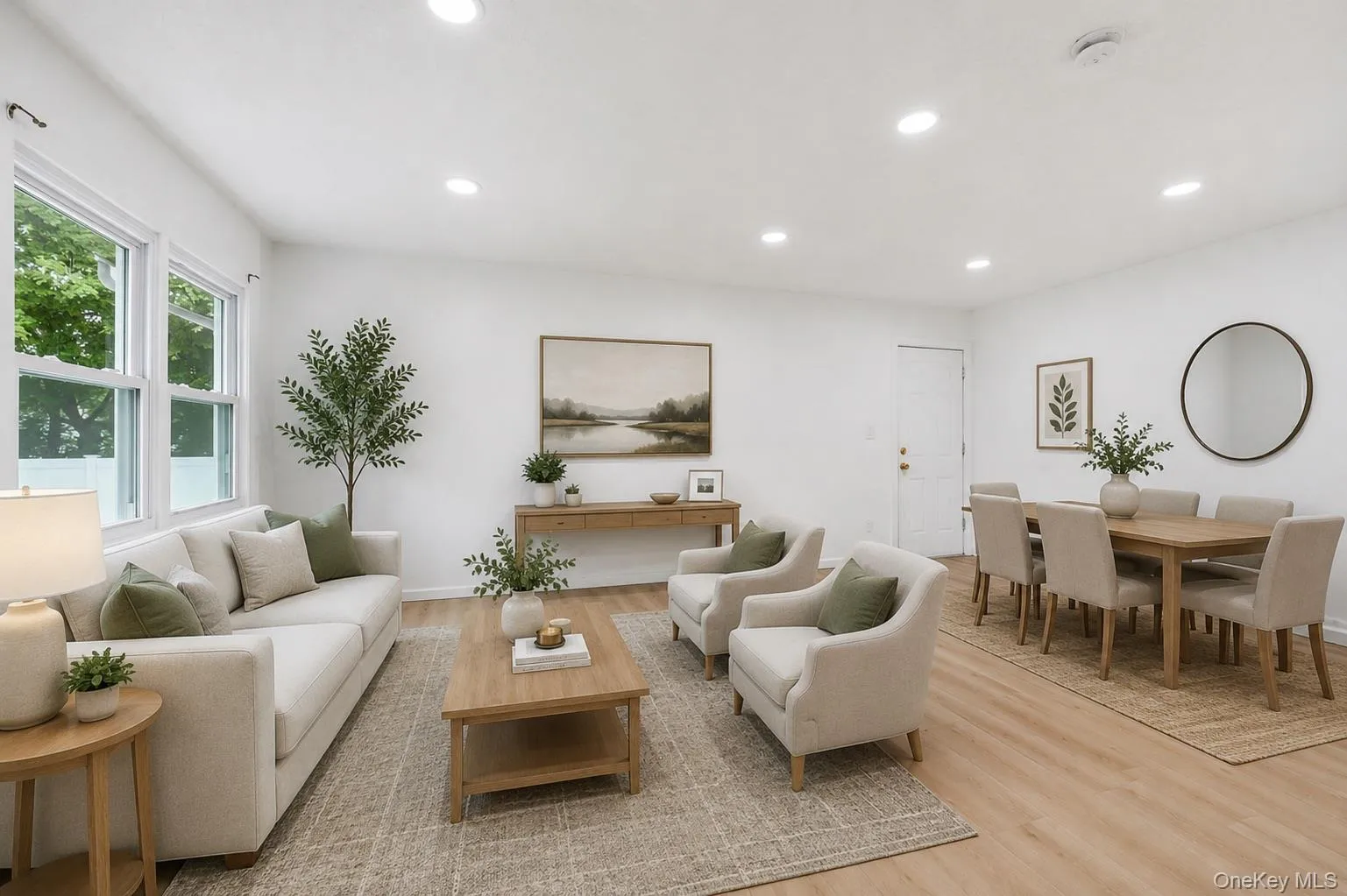 Open-concept living and dining area featuring recessed lighting, wood-finish flooring, and multiple windows Open-concept living and dining area featuring recessed lighting, wood-finish flooring, and multiple windows