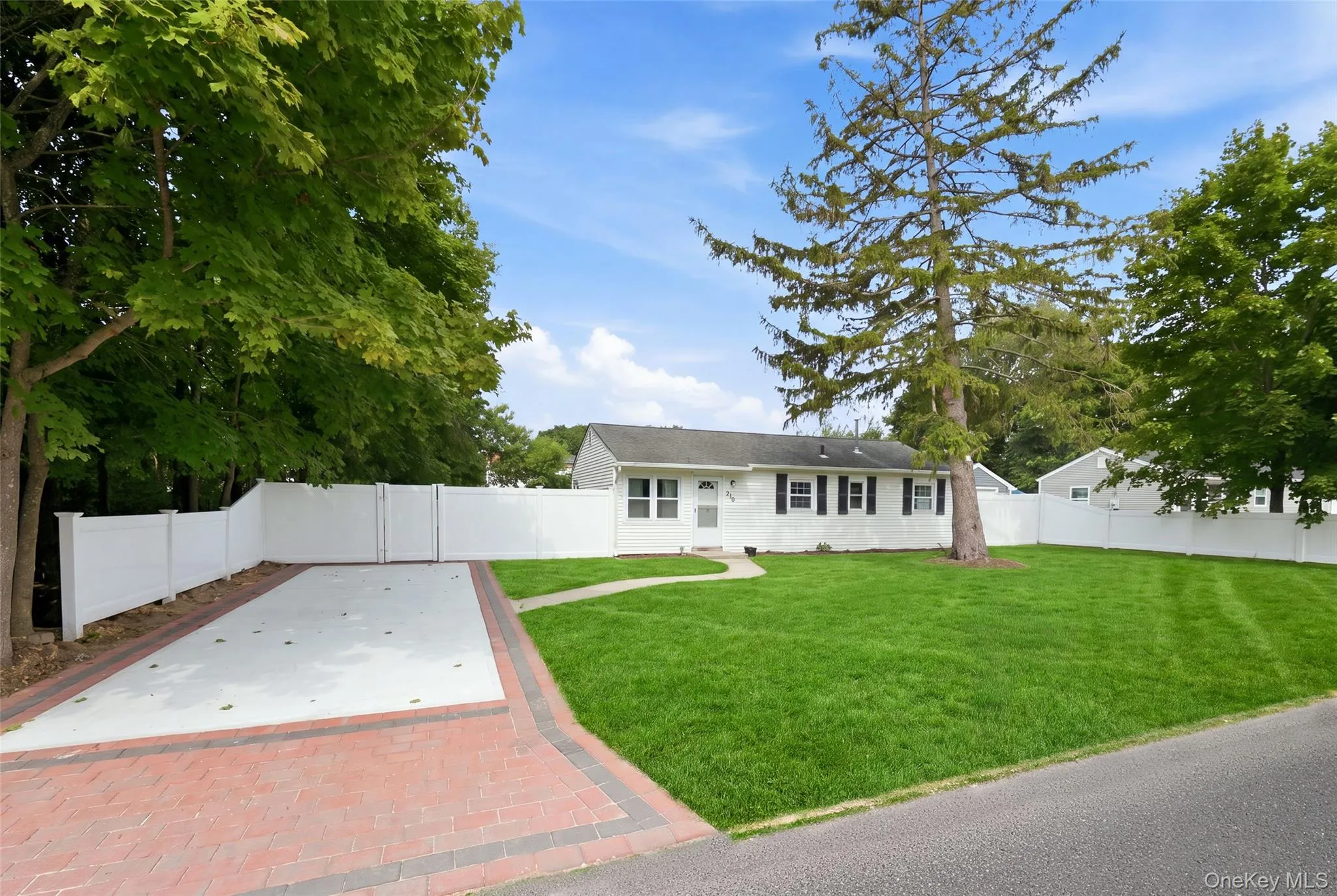 Ranch-style residence featuring a white exterior and black shutters Ranch-style residence featuring a white exterior and black shutters