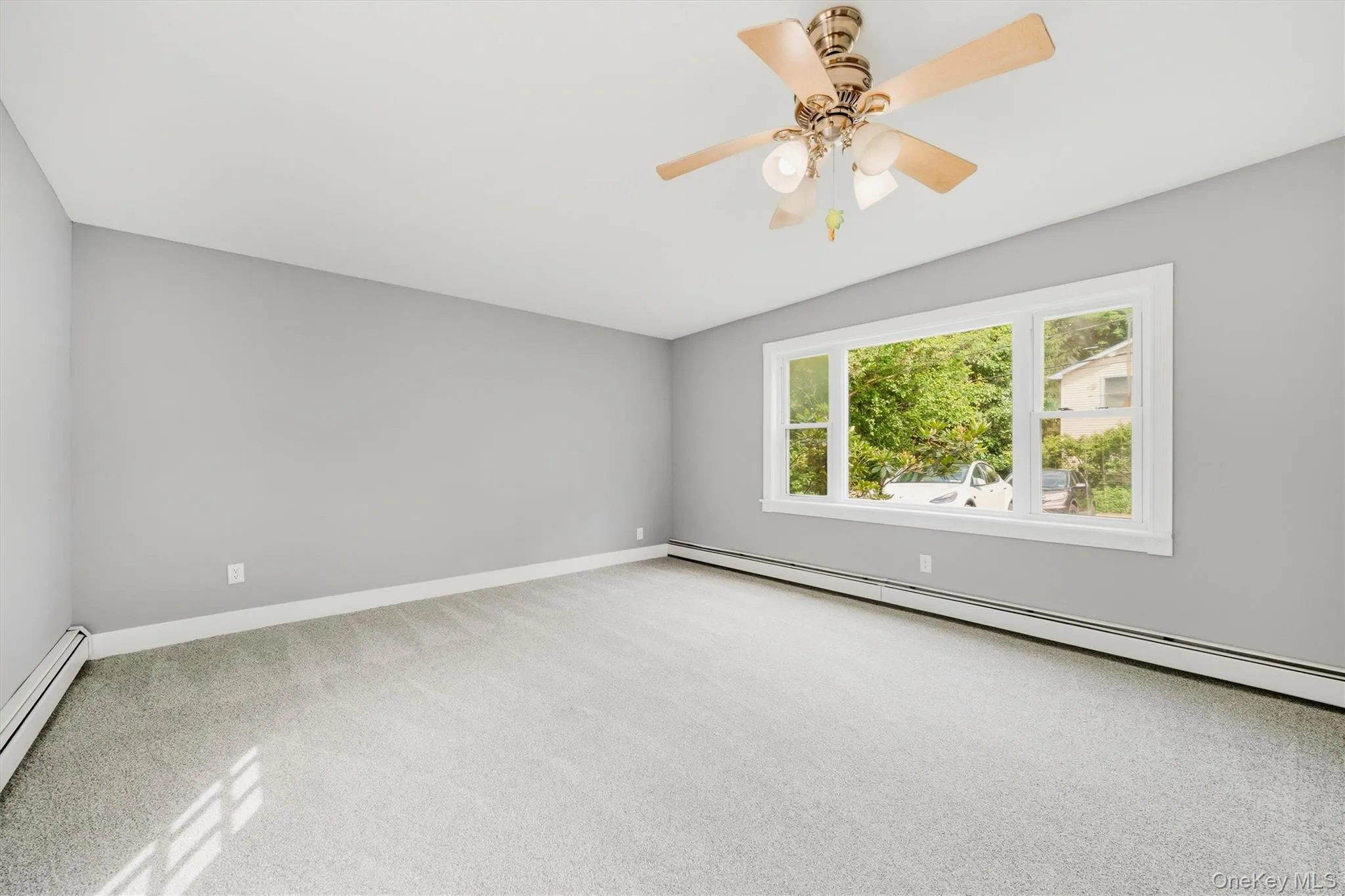 Spacious family flooded with natural light through windows overlooking mature landscaping Spacious family flooded with natural light through windows overlooking mature landscaping