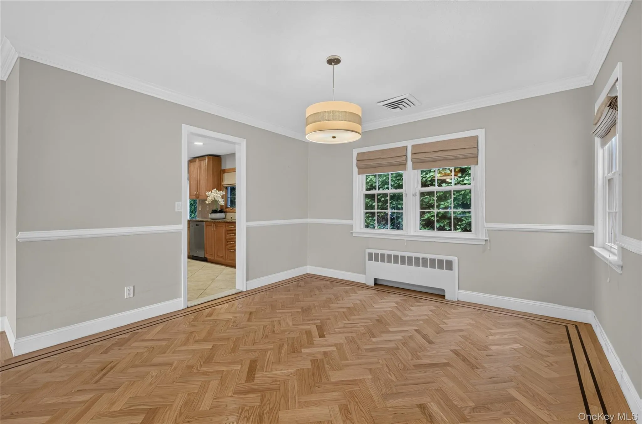 Herringbone wood-finish flooring with a border inlay Herringbone wood-finish flooring with a border inlay