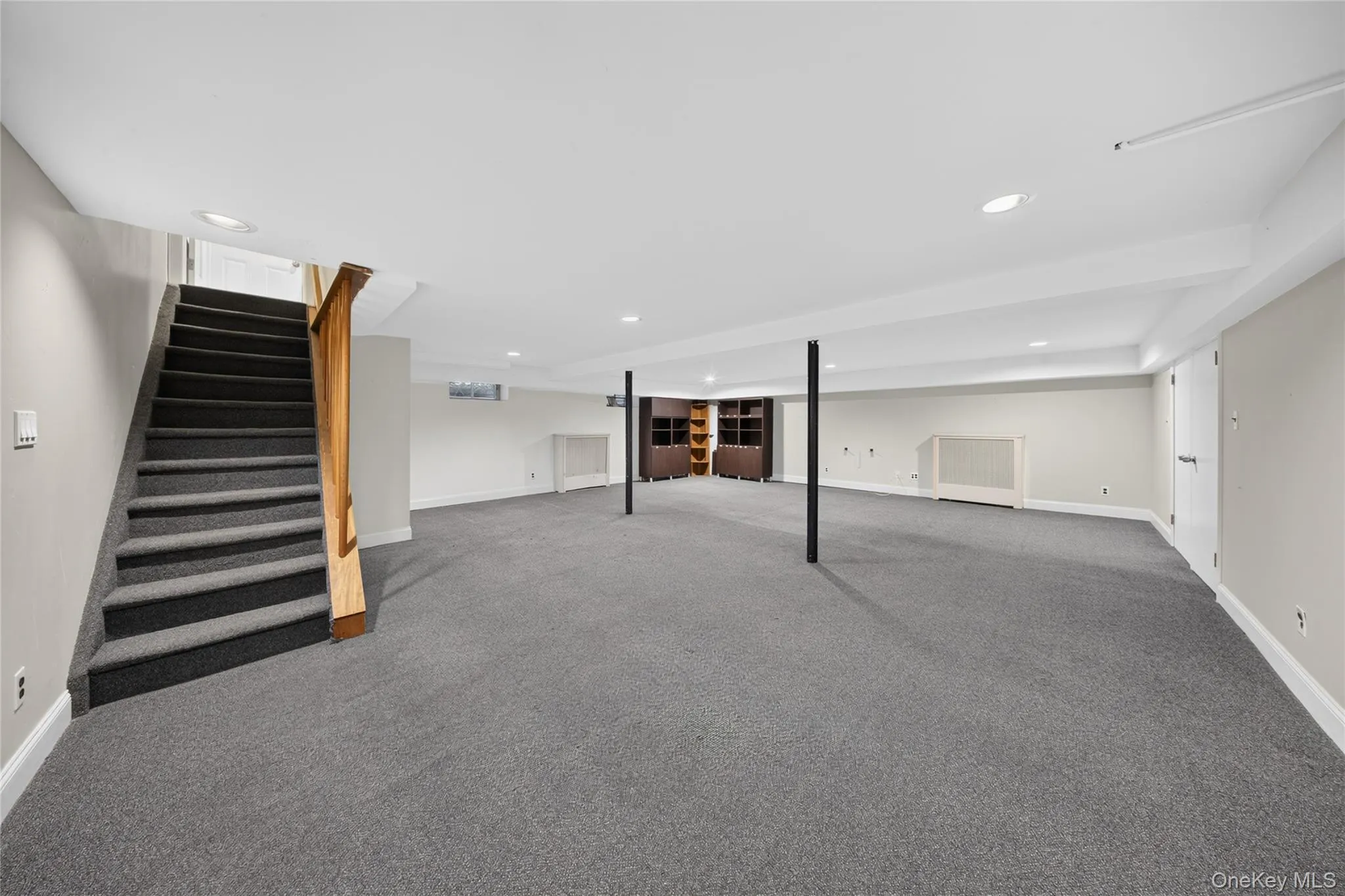 Finished lower level featuring neutral gray carpeting and recessed lighting Finished lower level featuring neutral gray carpeting and recessed lighting