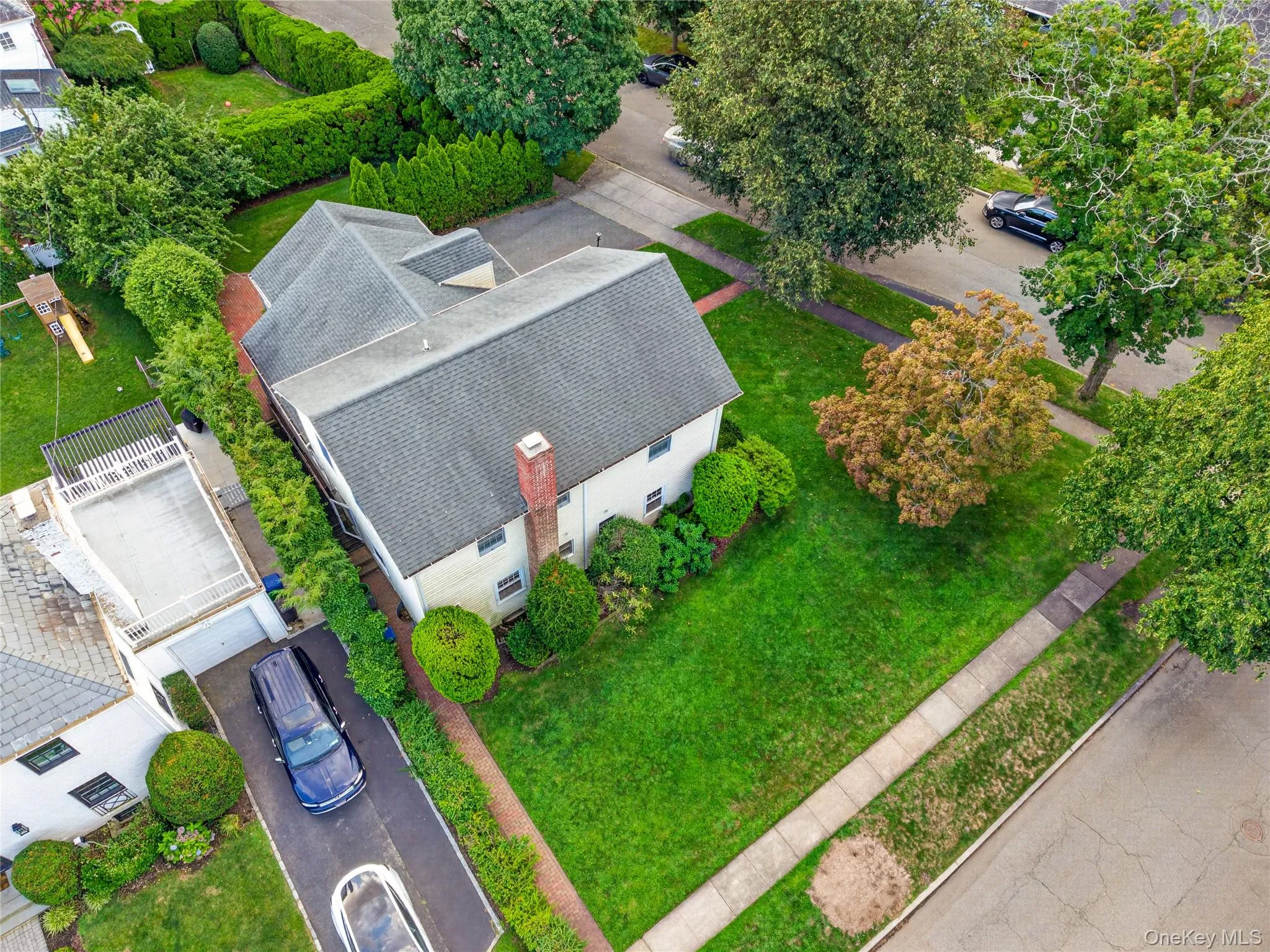 Two-story residence with a gabled roof and brick chimney Two-story residence with a gabled roof and brick chimney