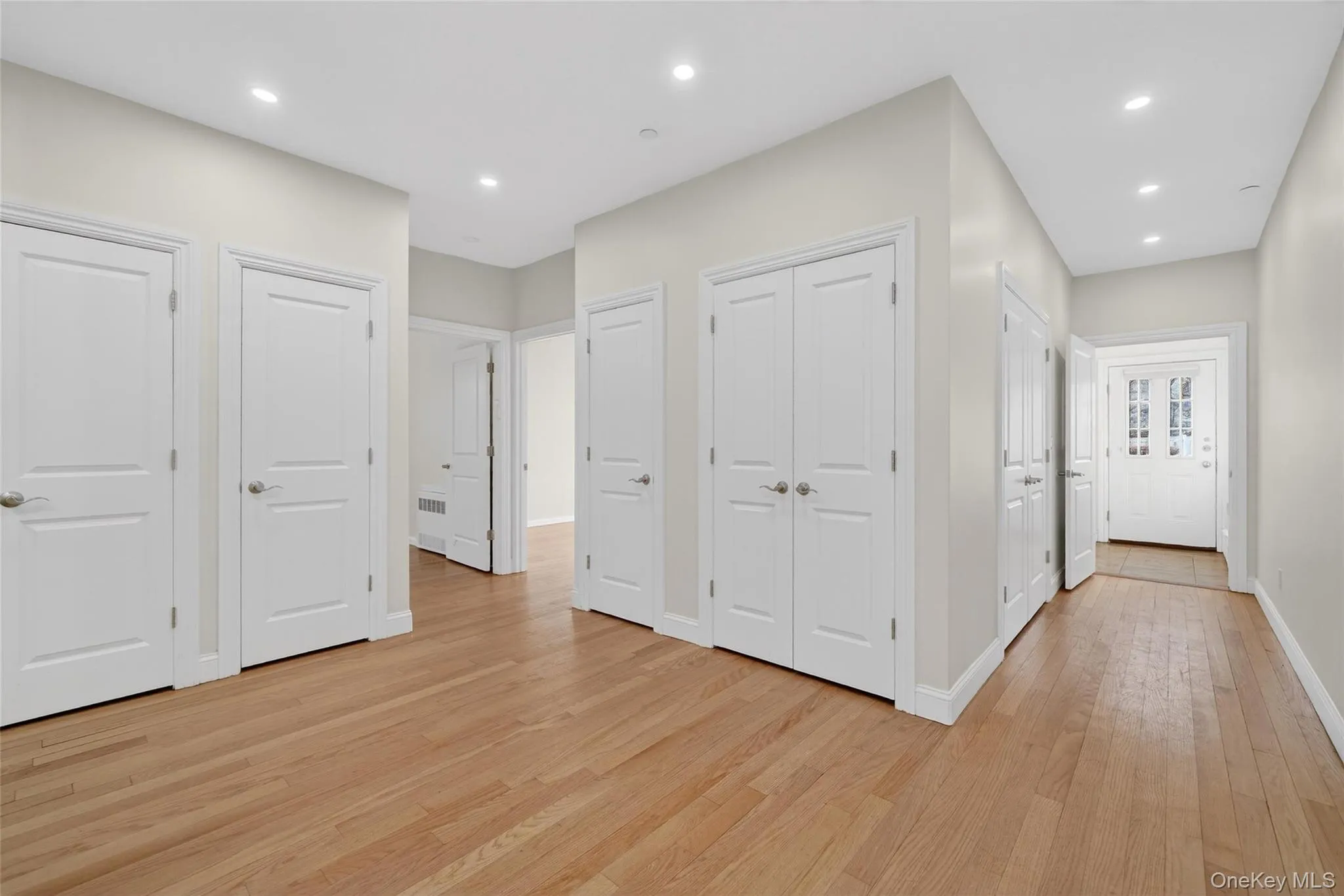Hall featuring light wood-style flooring and recessed lighting Hall featuring light wood-style flooring and recessed lighting