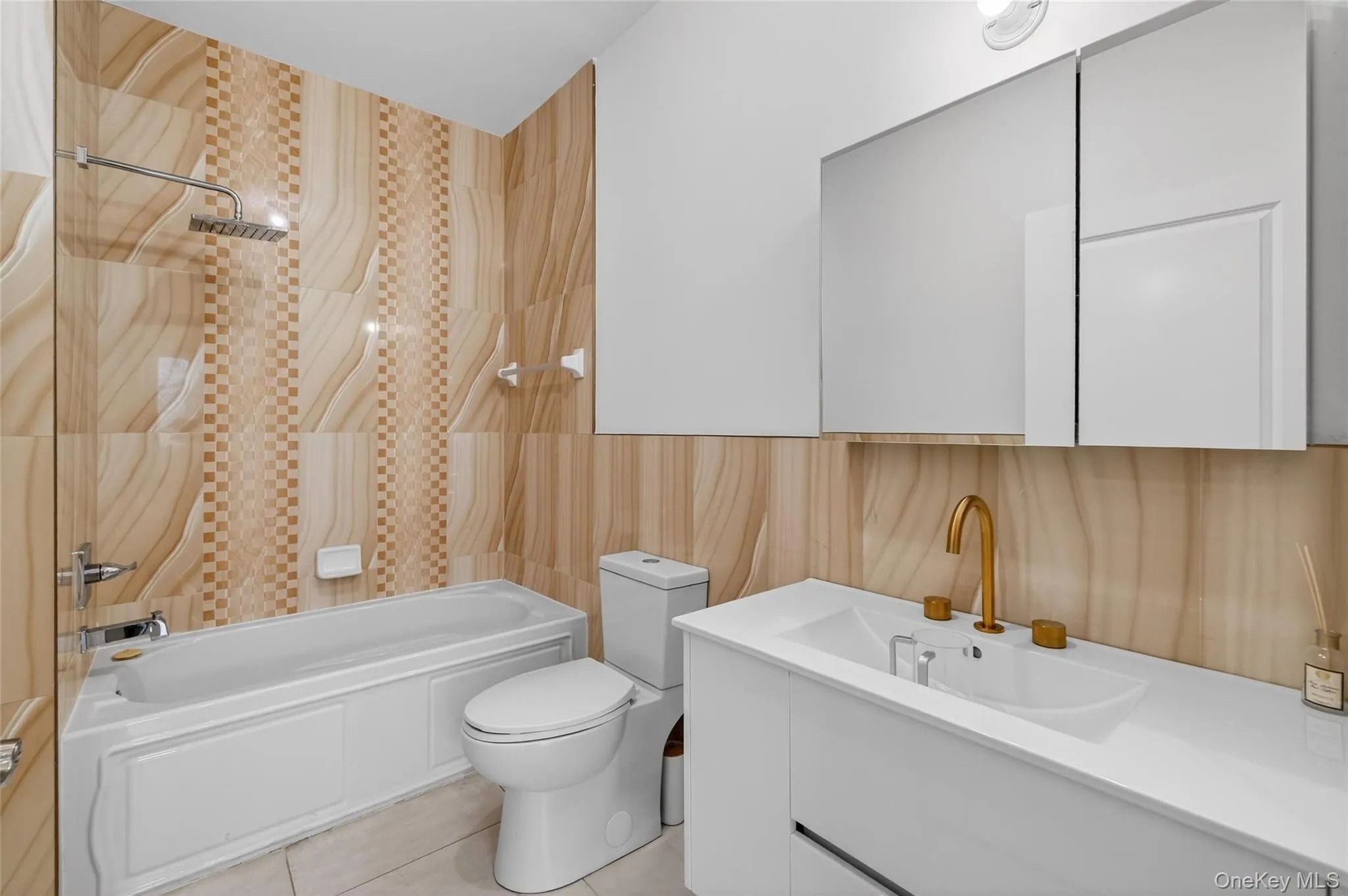 Full bath with vanity, washtub / shower combination, tile walls, and light tile patterned flooring Full bath with vanity, washtub / shower combination, tile walls, and light tile patterned flooring