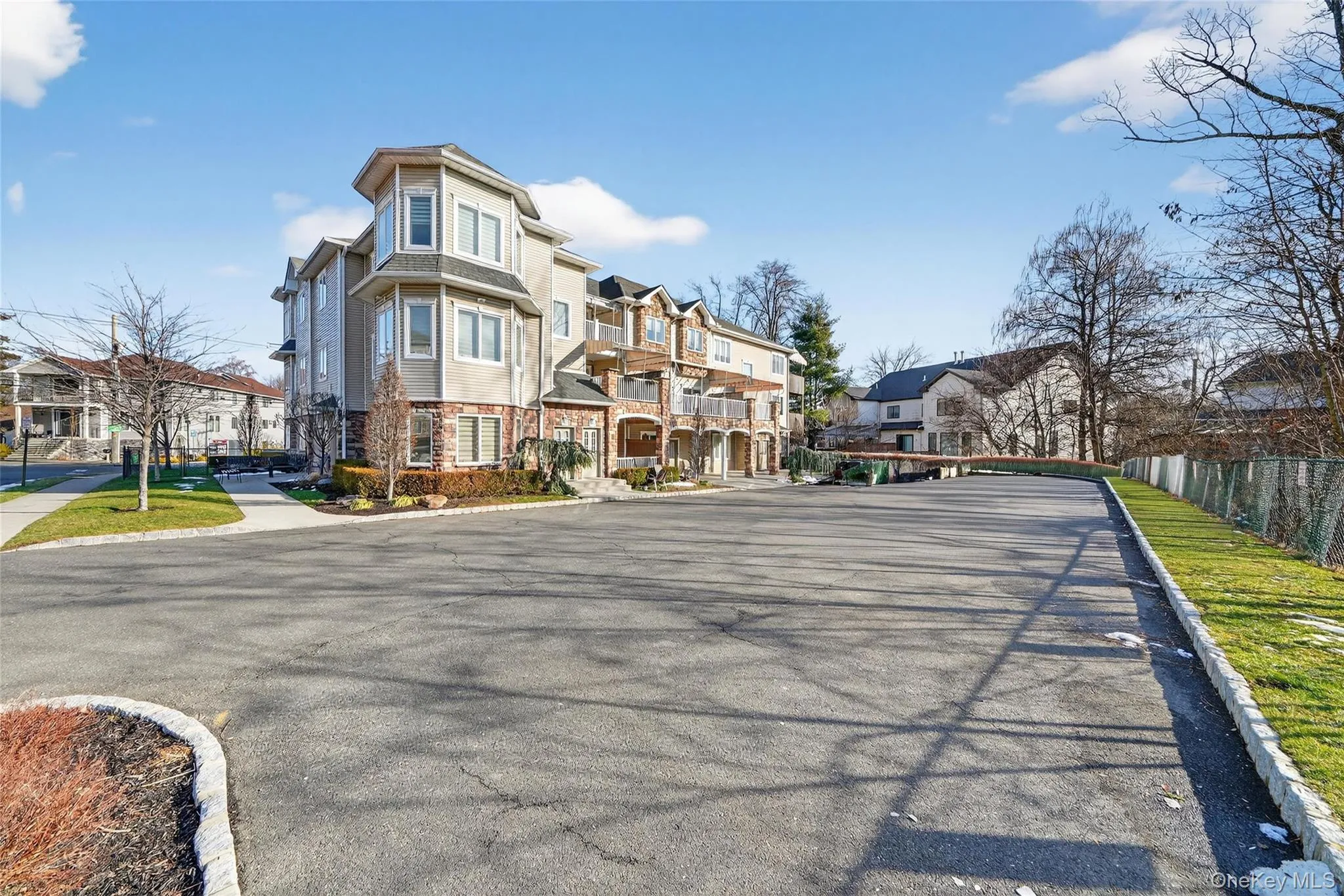View of asphalt street featuring a residential view, curbs, and sidewalks View of asphalt street featuring a residential view, curbs, and sidewalks