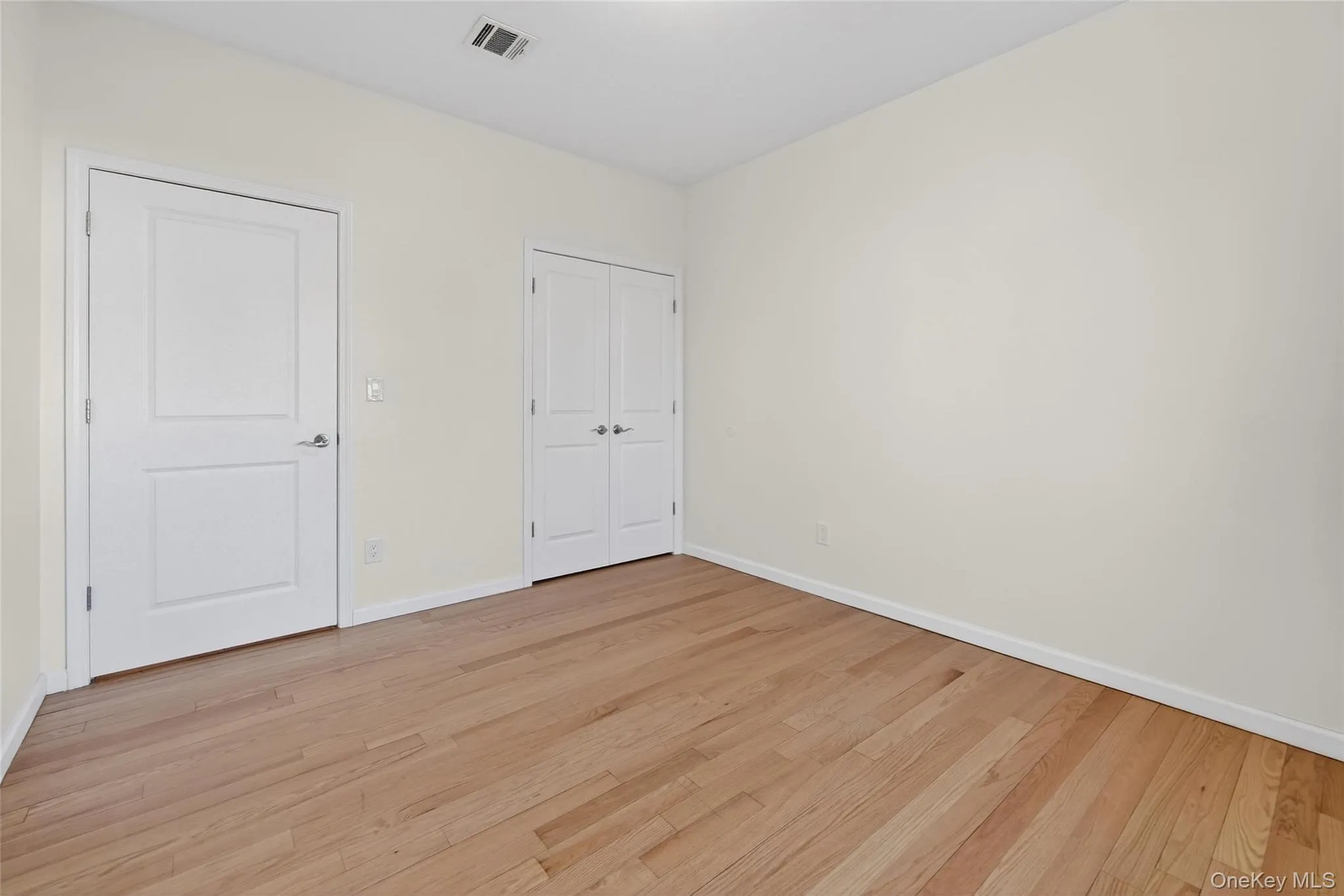 Unfurnished bedroom featuring light wood-type flooring and a closet Unfurnished bedroom featuring light wood-type flooring and a closet