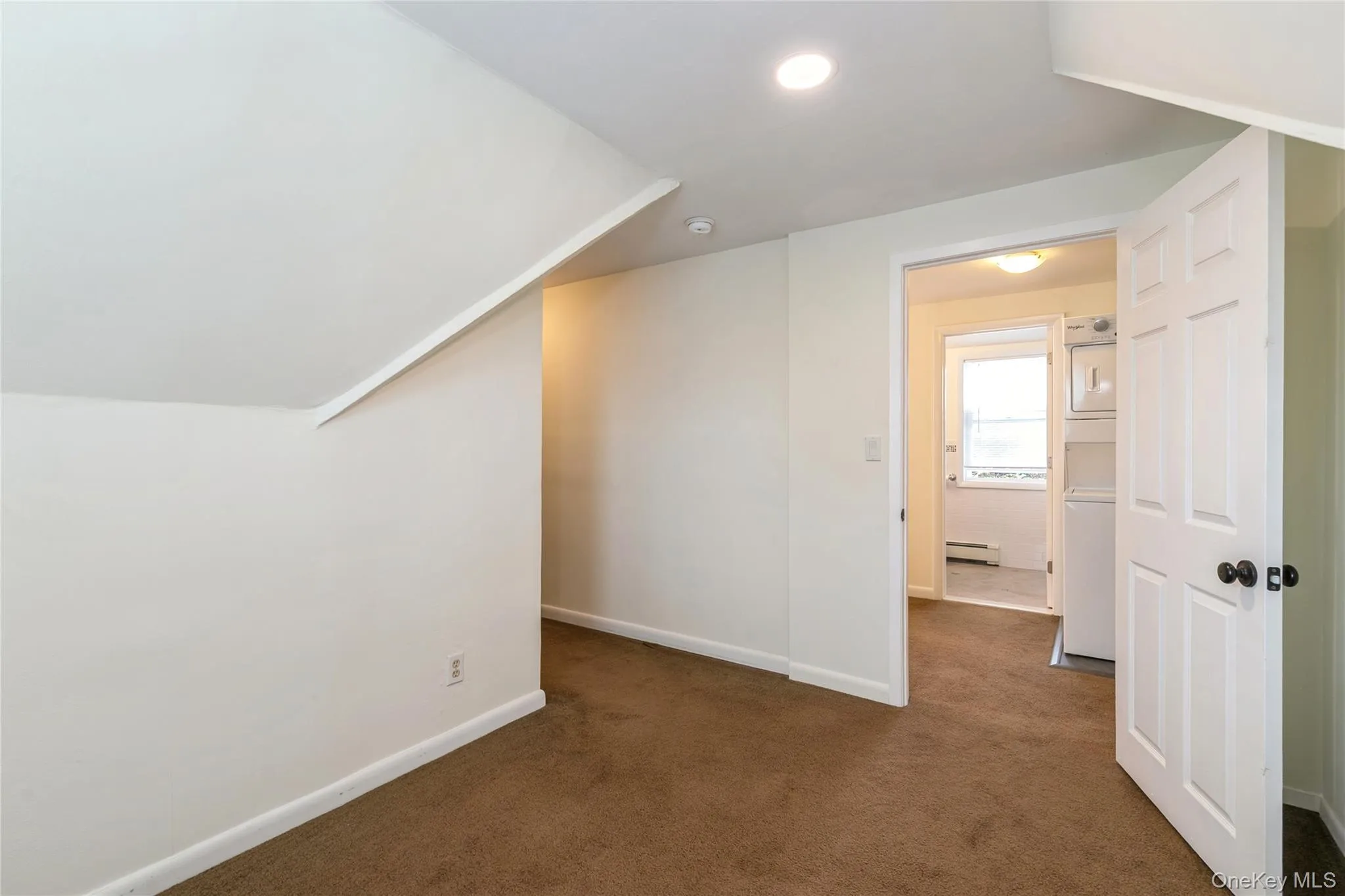 Primary bedroom with an adjoining walk-in closet and convenient access to the laundry, offering comfort and everyday functionality. Primary bedroom with an adjoining walk-in closet and convenient access to the laundry, offering comfort and everyday functionality.