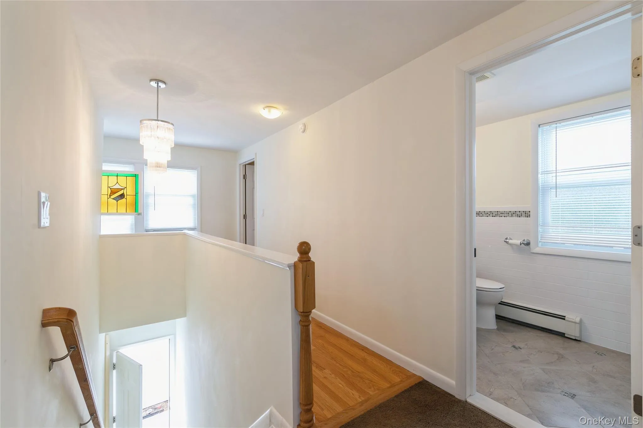 Bright second-floor landing with hardwood flooring, updated lighting, and easy access to the bedrooms and full bath. Bright second-floor landing with hardwood flooring, updated lighting, and easy access to the bedrooms and full bath.