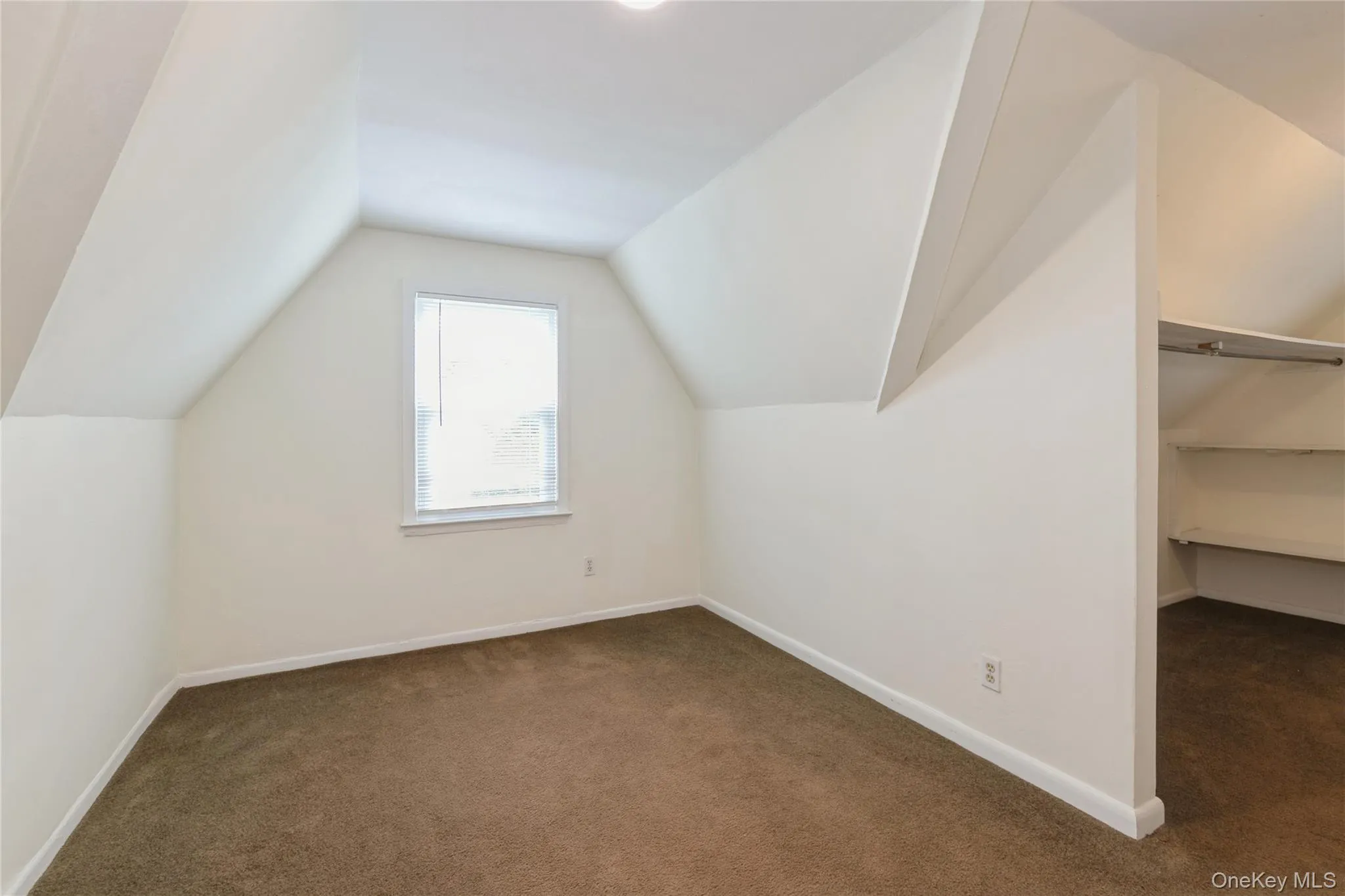 Charming primary bedroom with soft carpeting, natural light, and a spacious walk-in closet offering excellent storage and organization. Charming primary bedroom with soft carpeting, natural light, and a spacious walk-in closet offering excellent storage and organization.