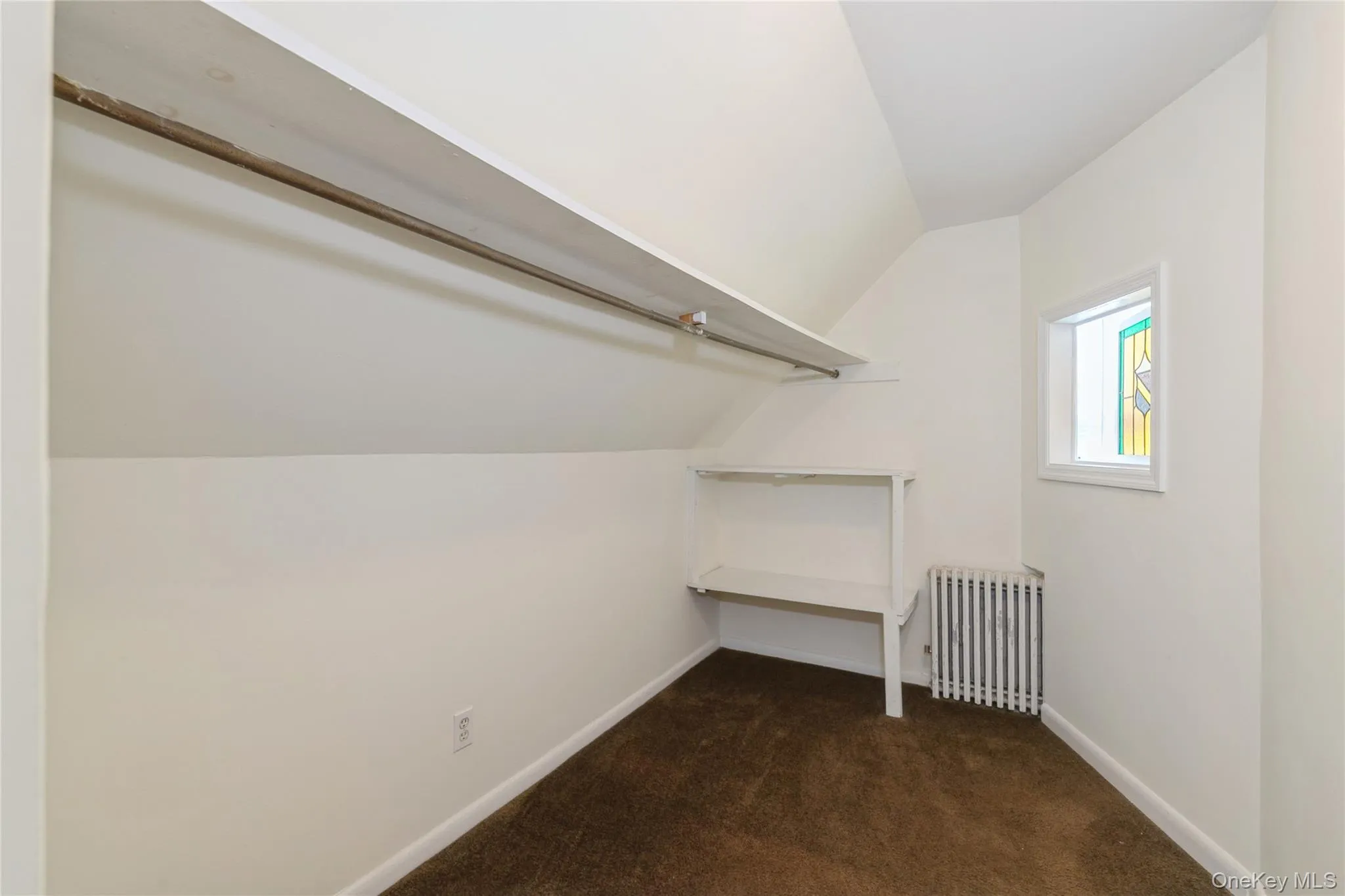 Spacious walk-in closet of primary bedroom with built-in shelving and hanging space, offering excellent storage and organization. Spacious walk-in closet of primary bedroom with built-in shelving and hanging space, offering excellent storage and organization.