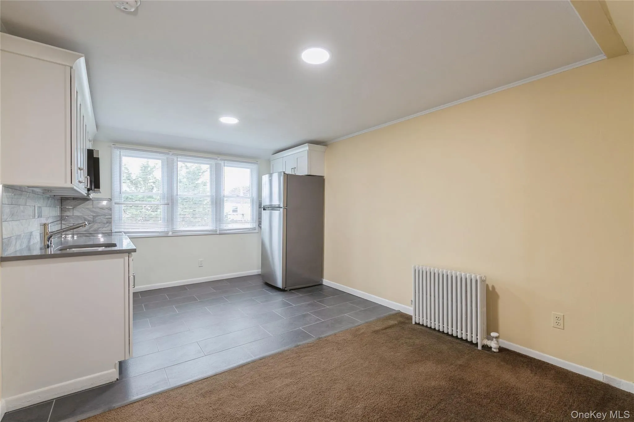Modern kitchen flows seamlessly into the inviting living area, creating an ideal gathering space. Modern kitchen flows seamlessly into the inviting living area, creating an ideal gathering space.