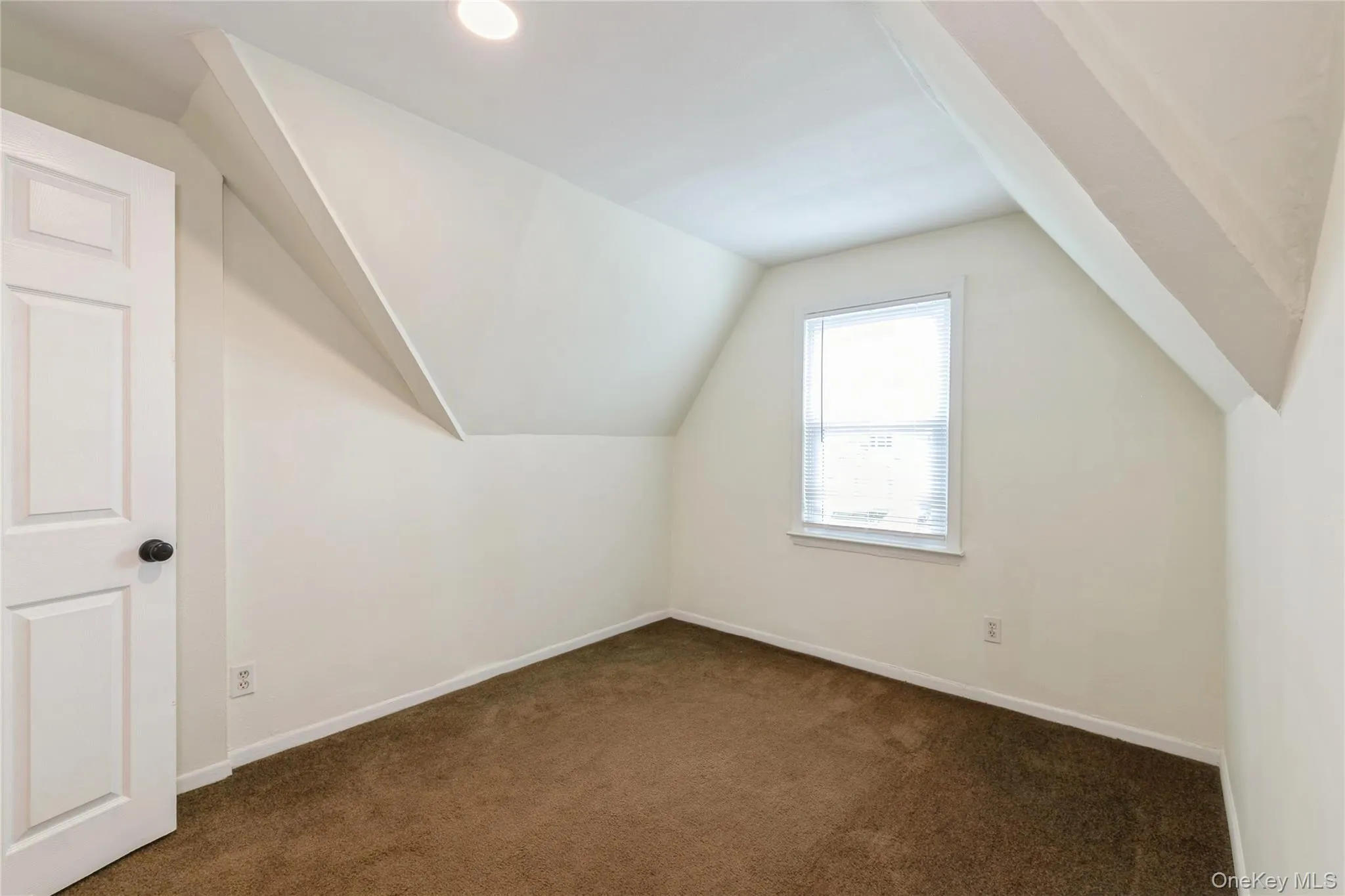 Comfortable primary bedroom with soft carpeting, natural light, and charming architectural details that create a warm and inviting retreat. Comfortable primary bedroom with soft carpeting, natural light, and charming architectural details that create a warm and inviting retreat.