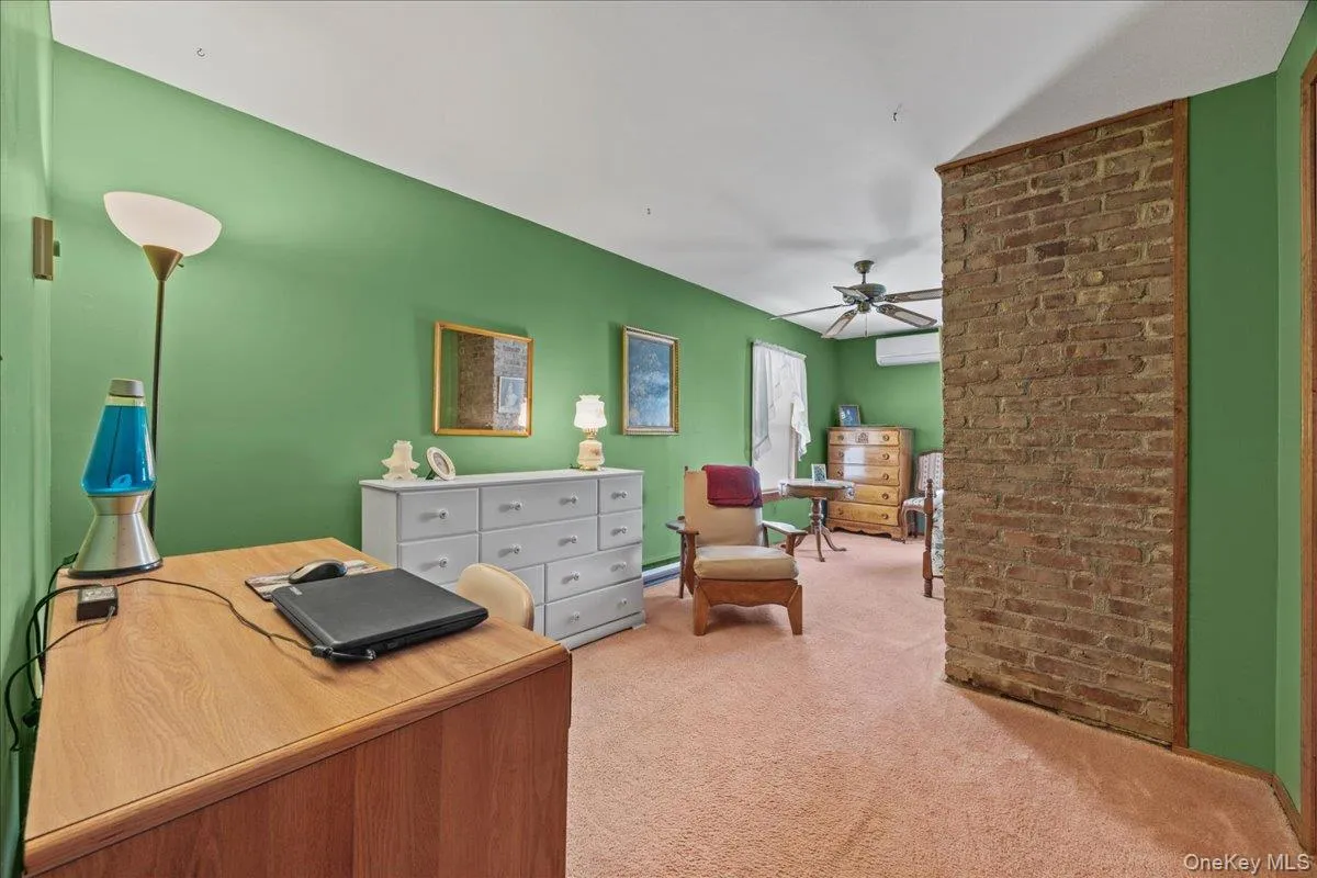 Generous sized guest bedroom with impressive closet space and exposed brick accent. Generous sized guest bedroom with impressive closet space and exposed brick accent.