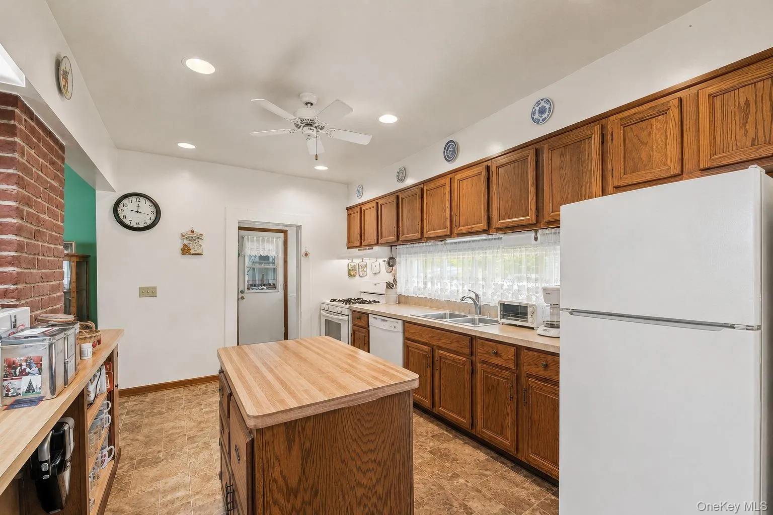 Kitchen includes recessed lighting, exposed brick chimney accent as well as access to a full pantry and separate entrance. Kitchen includes recessed lighting, exposed brick chimney accent as well as access to a full pantry and separate entrance.
