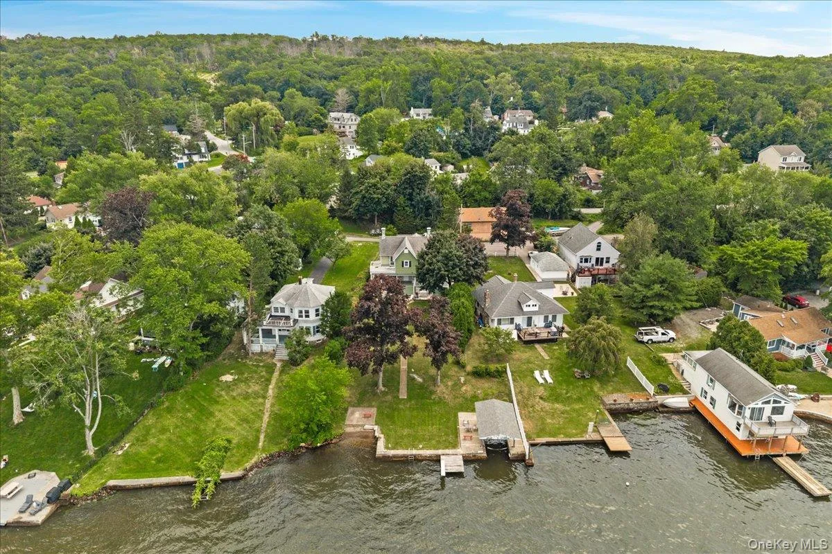 Large backyard features covered boat slip with winch, walk-in lake access and diving board. Large backyard features covered boat slip with winch, walk-in lake access and diving board.