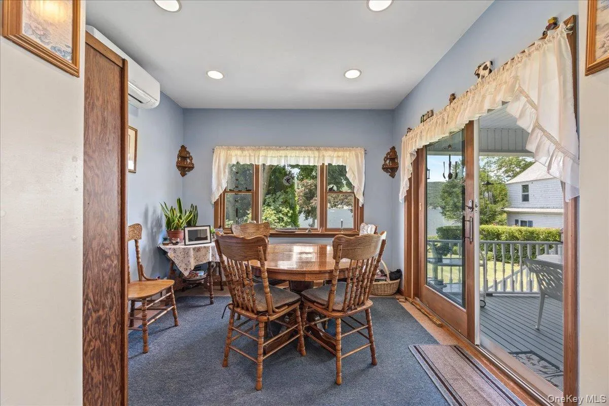 Gorgeous dining area just off the kitchen with fabulous lake views and sliders leading to the rear porch. Gorgeous dining area just off the kitchen with fabulous lake views and sliders leading to the rear porch.