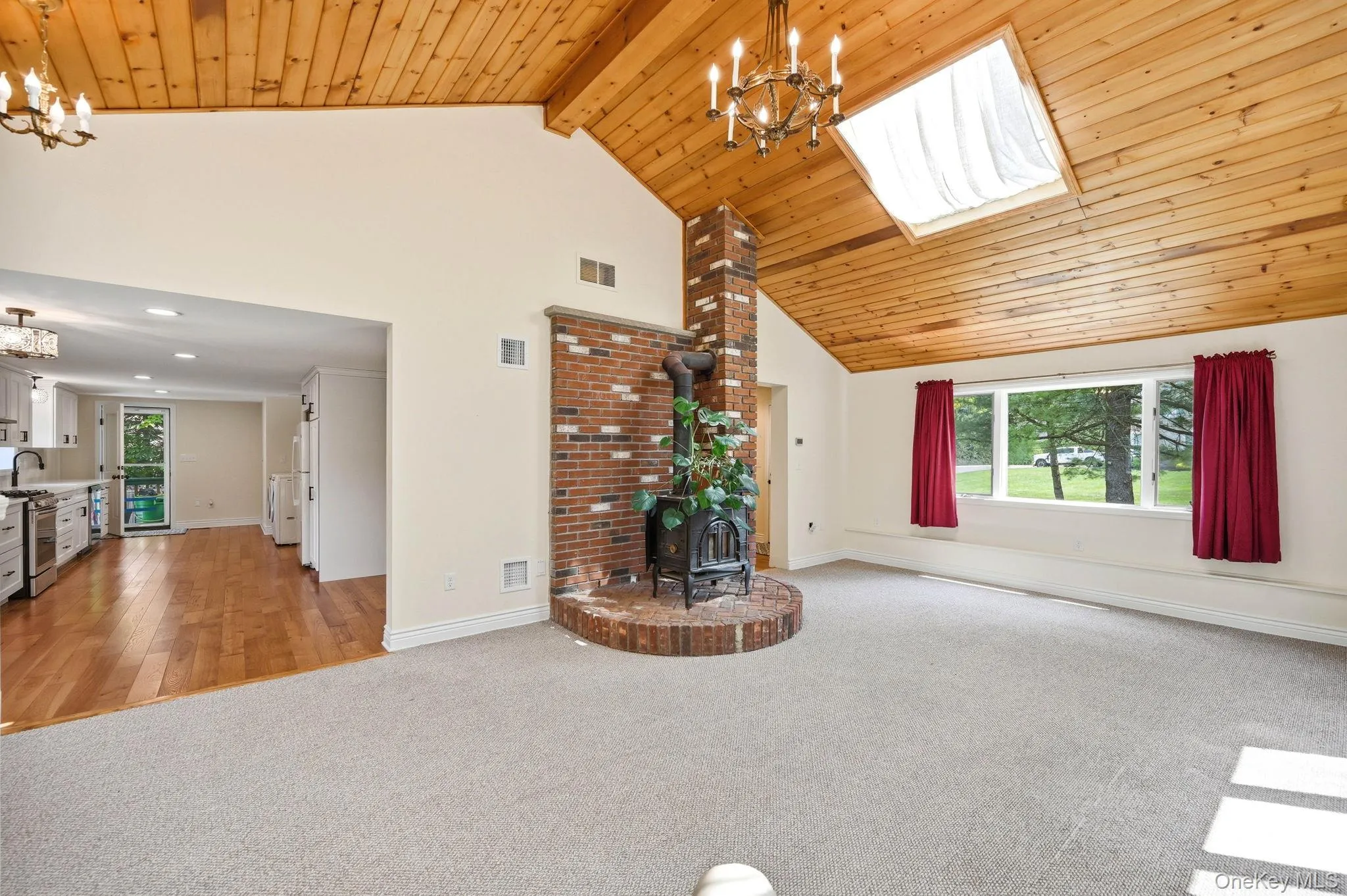 Spacious Living Room with a Wood Cathedral Ceiling. So Charming. Spacious Living Room with a Wood Cathedral Ceiling. So Charming.