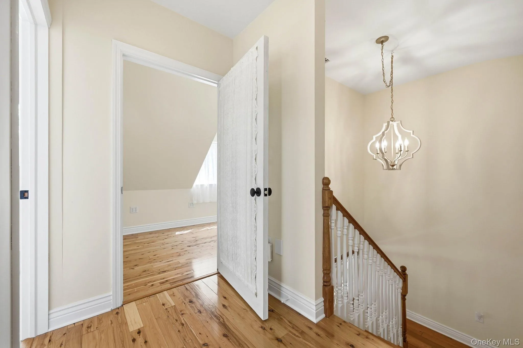 Upper Level Hallway Leading to Bedrooms.The details in this home are A Plus, from the wood flooring to the staircase the 5 Panel Doors and the beautiful Chandelier above. Upper Level Hallway Leading to Bedrooms.The details in this home are A Plus, from the wood flooring to the staircase the 5 Panel Doors and the beautiful Chandelier above.