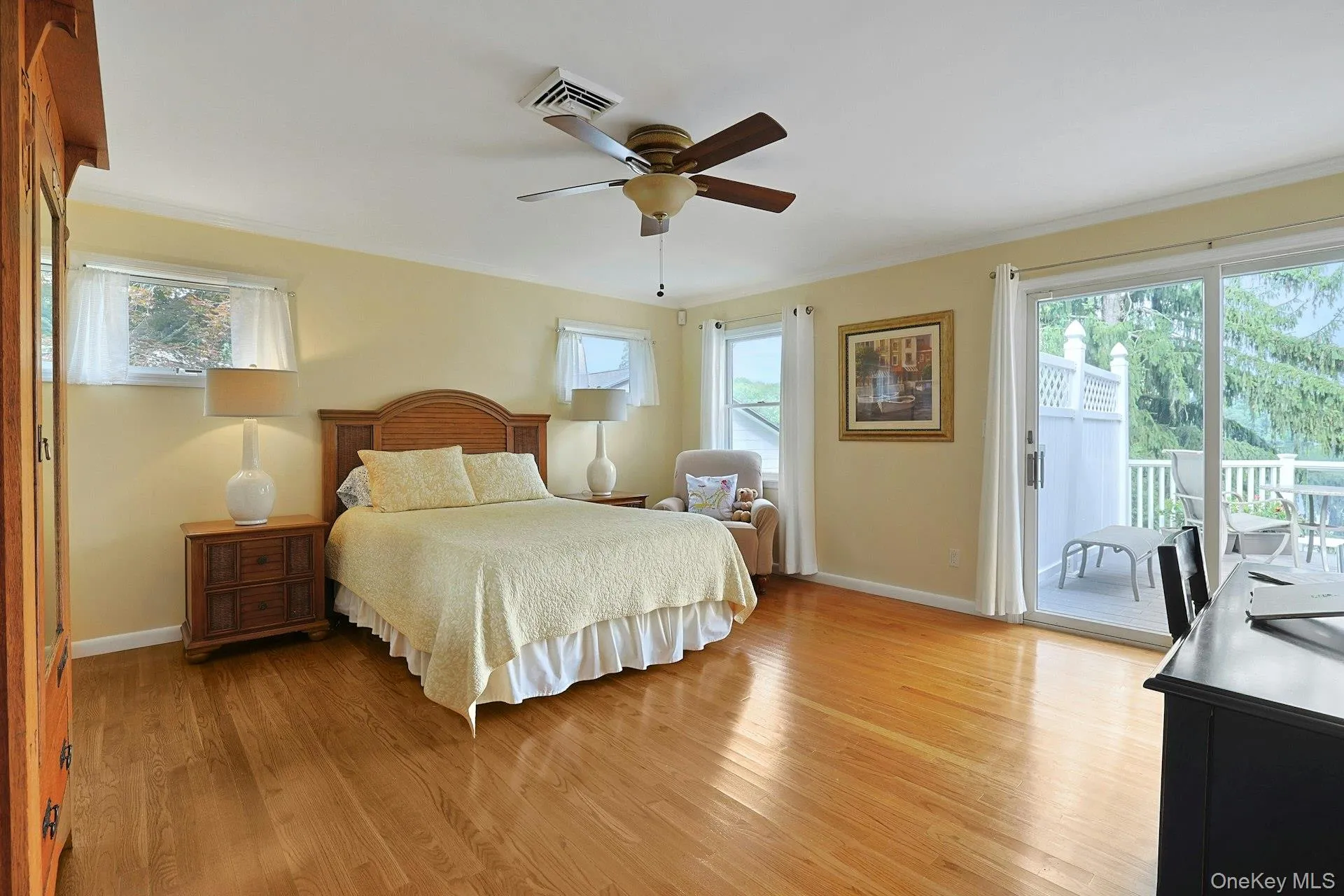 Wake up to breathtaking lake views in the spacious primary bedroom, complete with a sliding glass door that opens to the deck Wake up to breathtaking lake views in the spacious primary bedroom, complete with a sliding glass door that opens to the deck