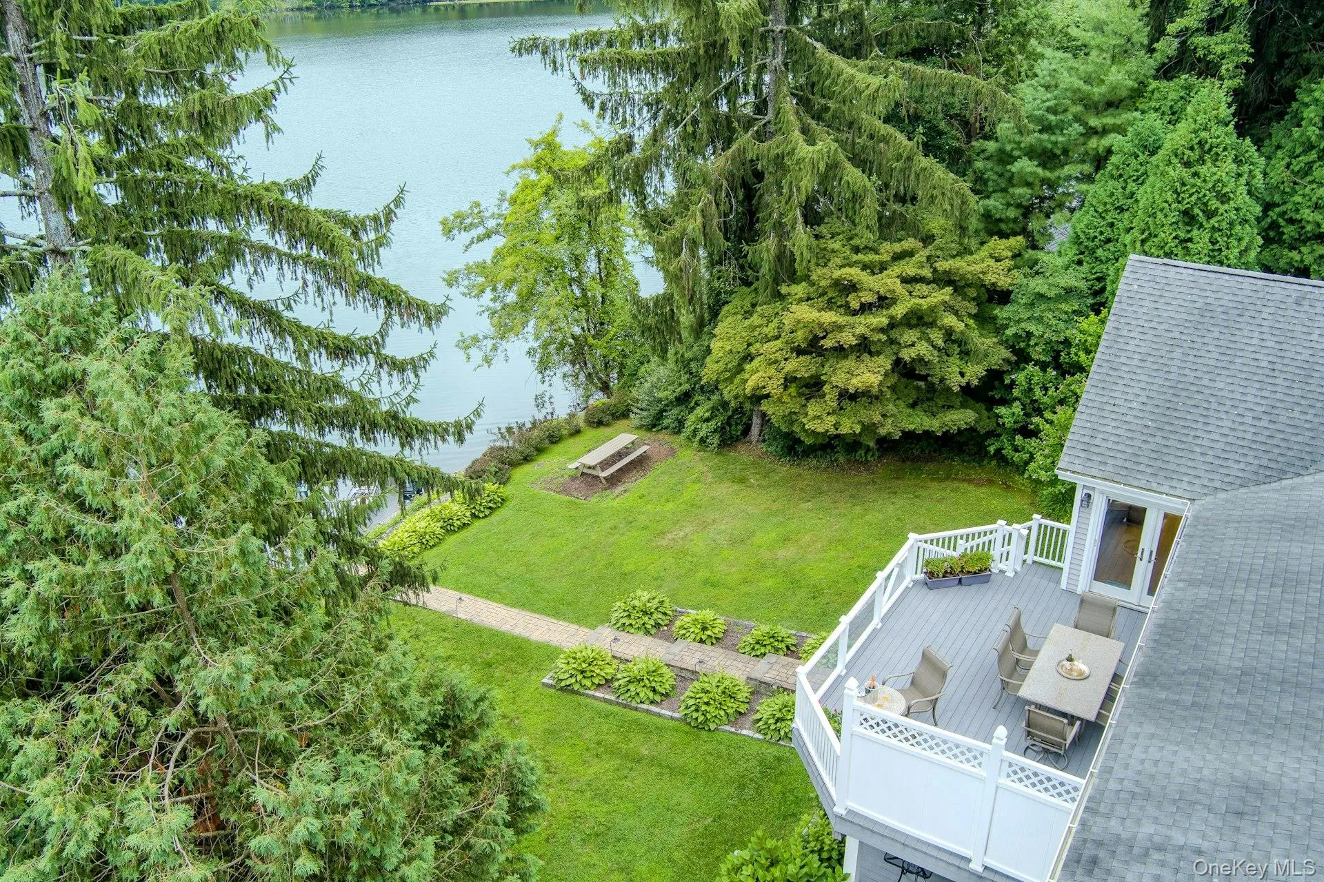 An aerial perspective highlights the expansive deck and short walk to the lake An aerial perspective highlights the expansive deck and short walk to the lake