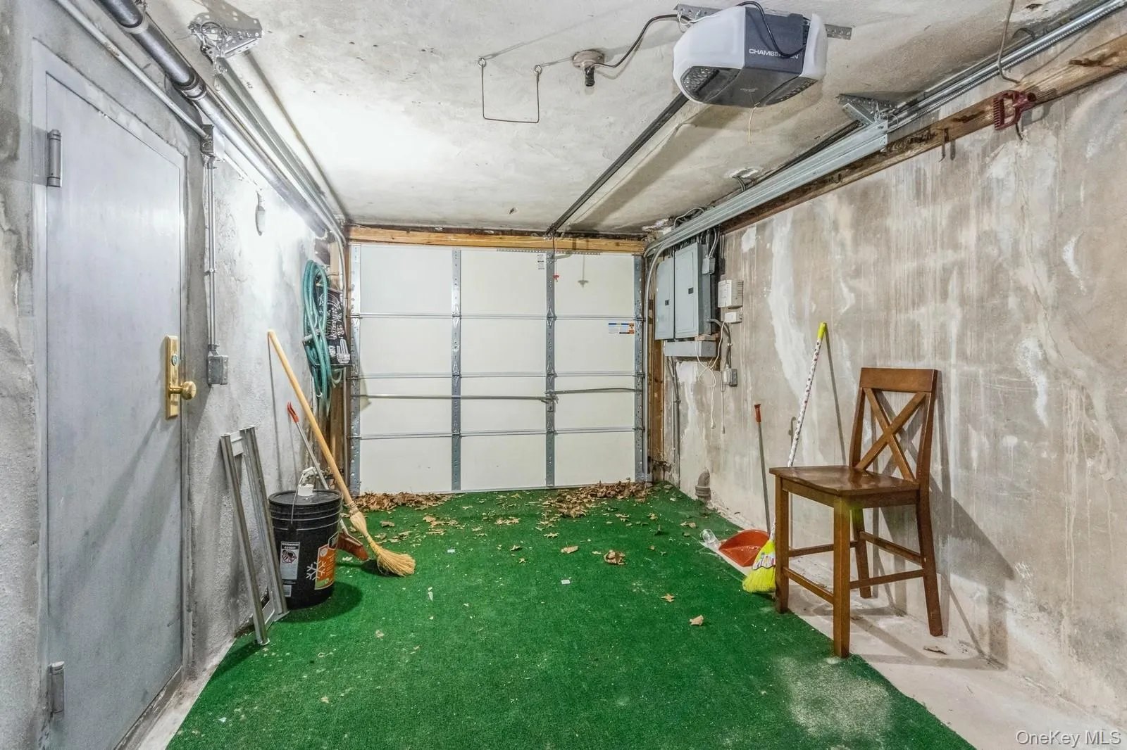 Garage featuring electric panel and a garage door opener Garage featuring electric panel and a garage door opener