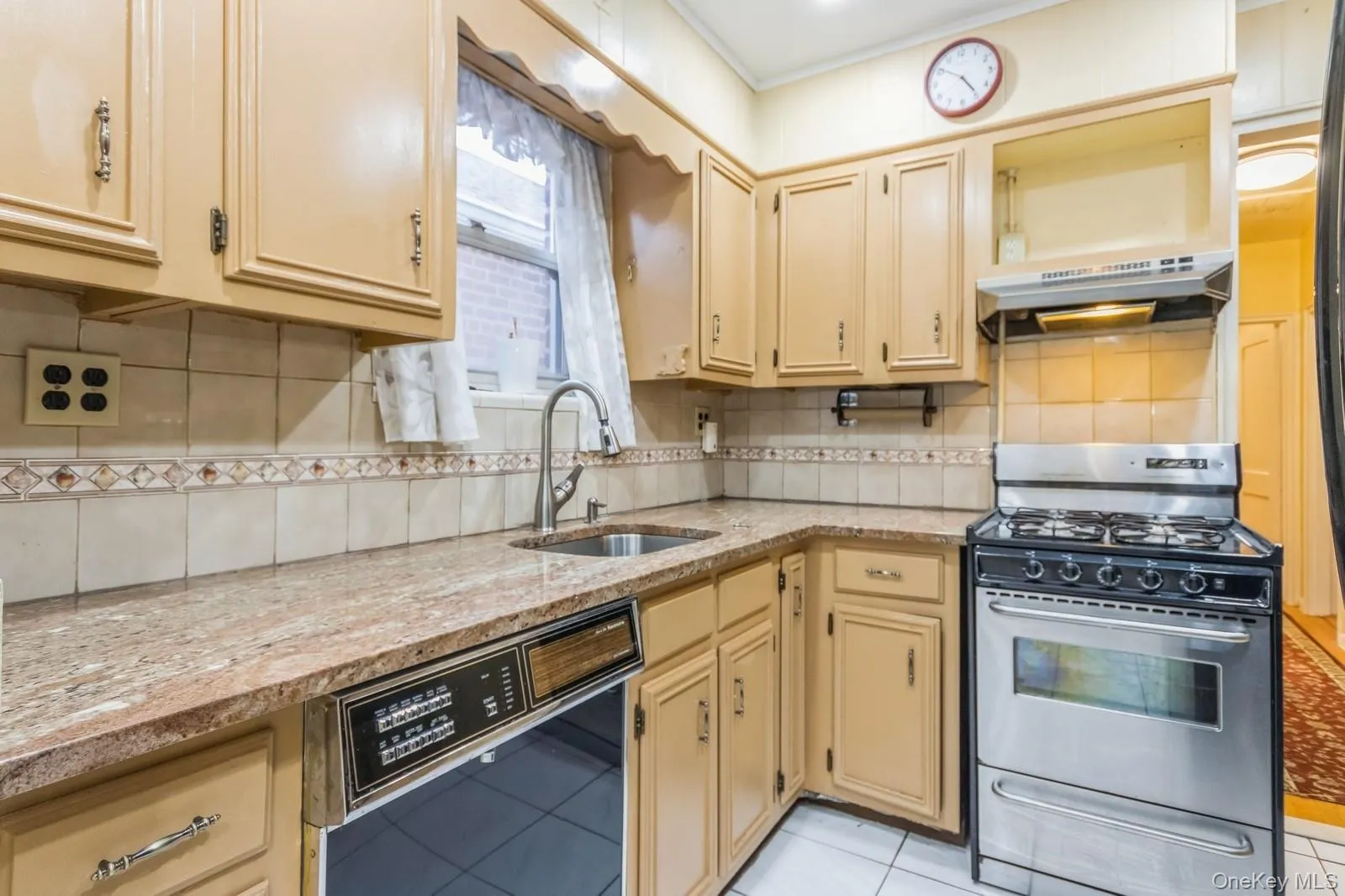 Kitchen with dishwasher, a sink, stainless steel gas range. Kitchen with dishwasher, a sink, stainless steel gas range.