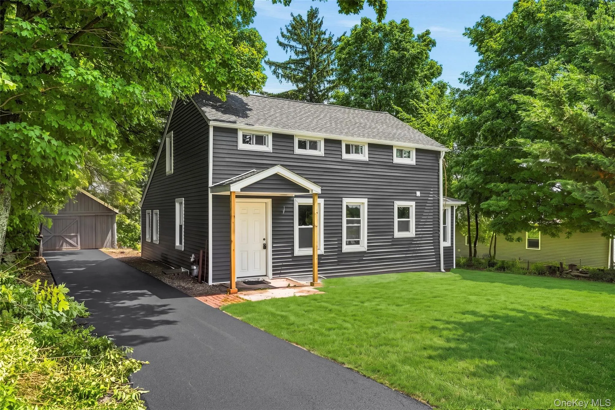 Dark gray siding exterior with white window trim Dark gray siding exterior with white window trim