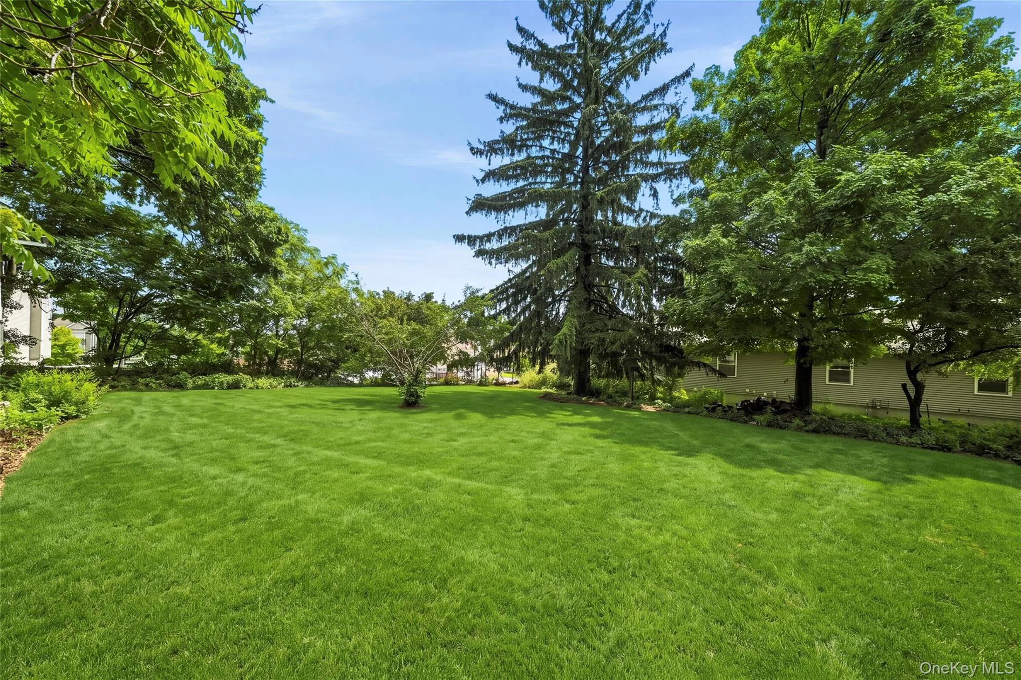 Expansive lawn area featuring mature trees and established perimeter landscaping Expansive lawn area featuring mature trees and established perimeter landscaping