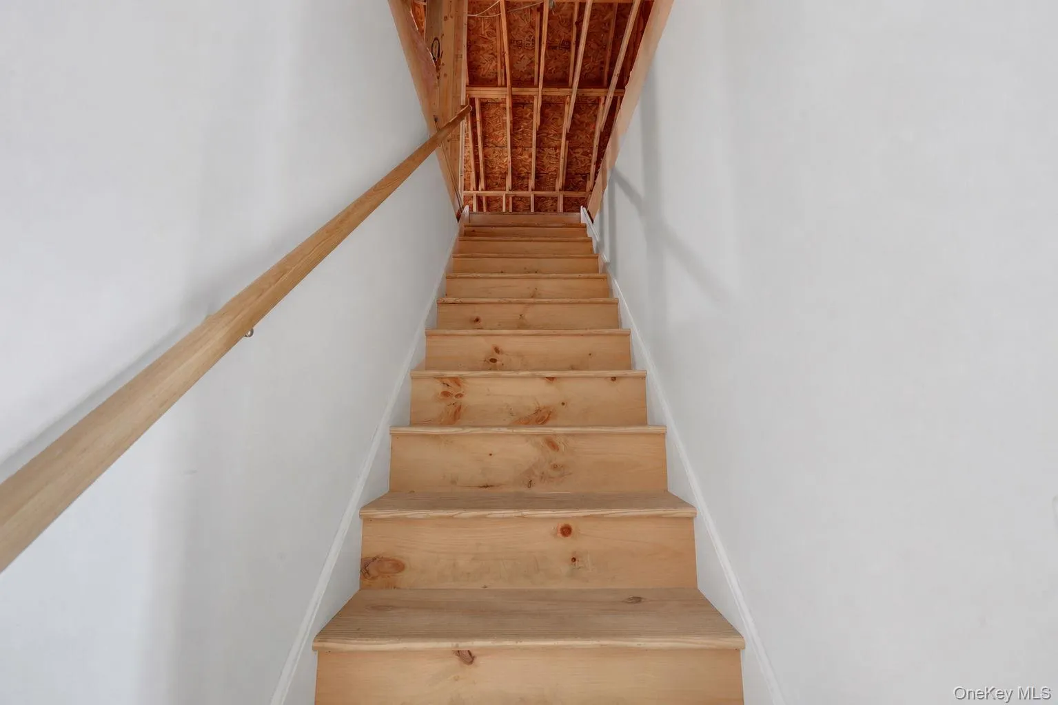 Staircase into attic with large storage area. Staircase into attic with large storage area.