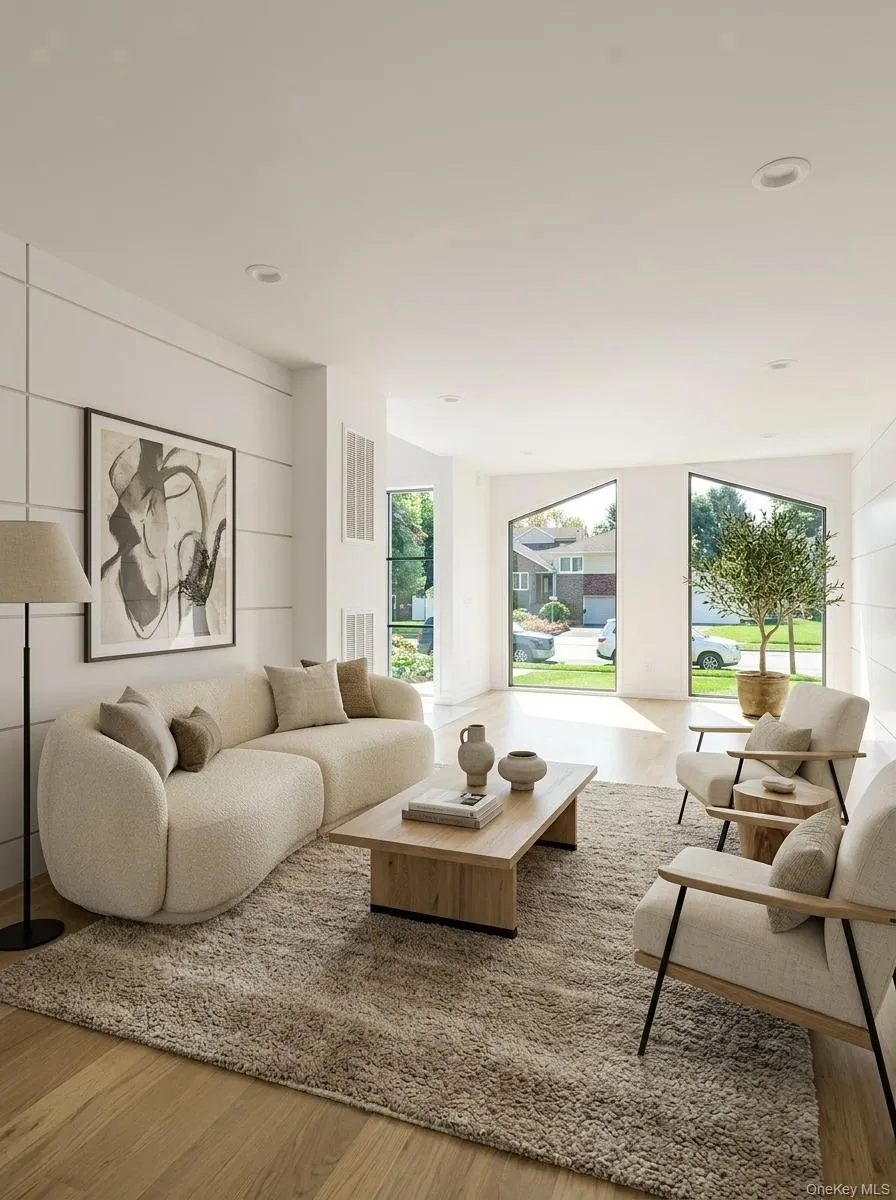 Living area featuring light wood-finish flooring, recessed lighting, and large picture windows Living area featuring light wood-finish flooring, recessed lighting, and large picture windows