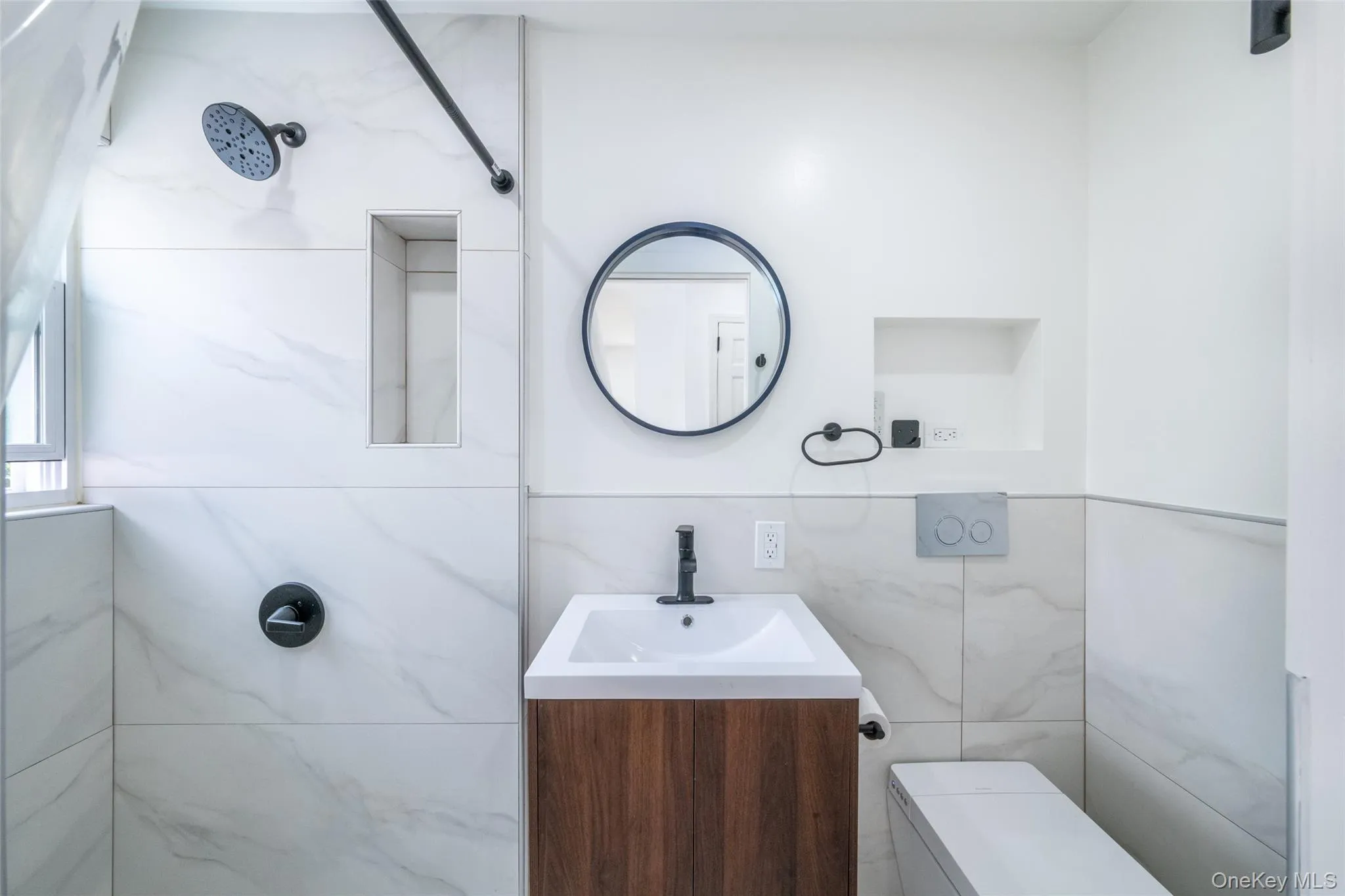 The guest bathroom off of the main level living area offers a sleek and modern set up. The guest bathroom off of the main level living area offers a sleek and modern set up.