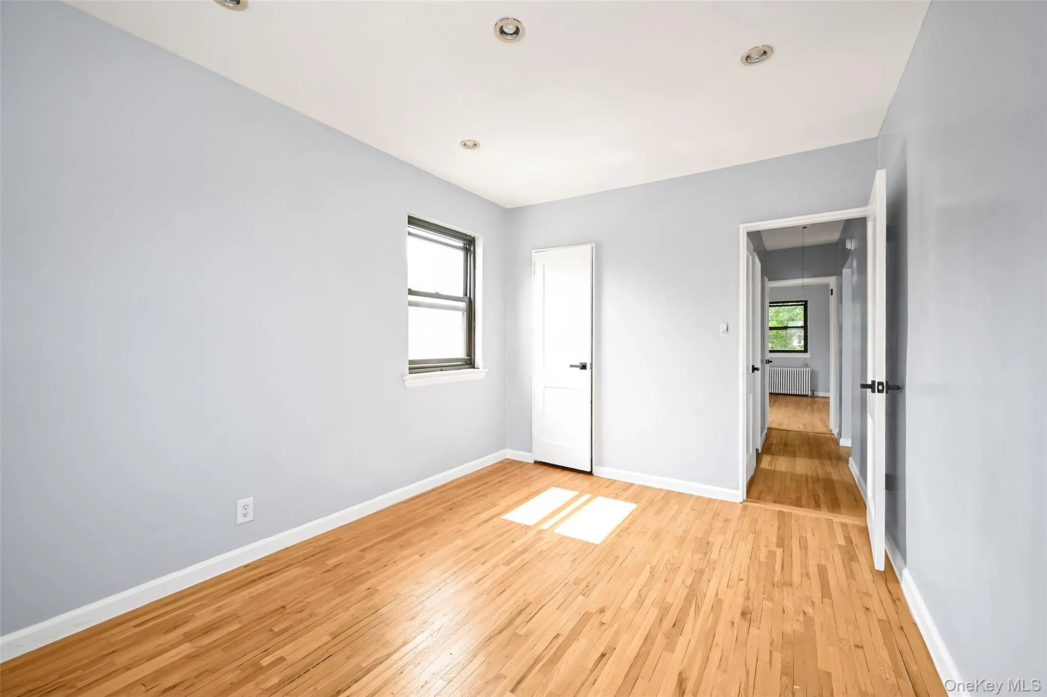 Hardwood flooring throughout, recessed lighting, and a window with natural light Hardwood flooring throughout, recessed lighting, and a window with natural light