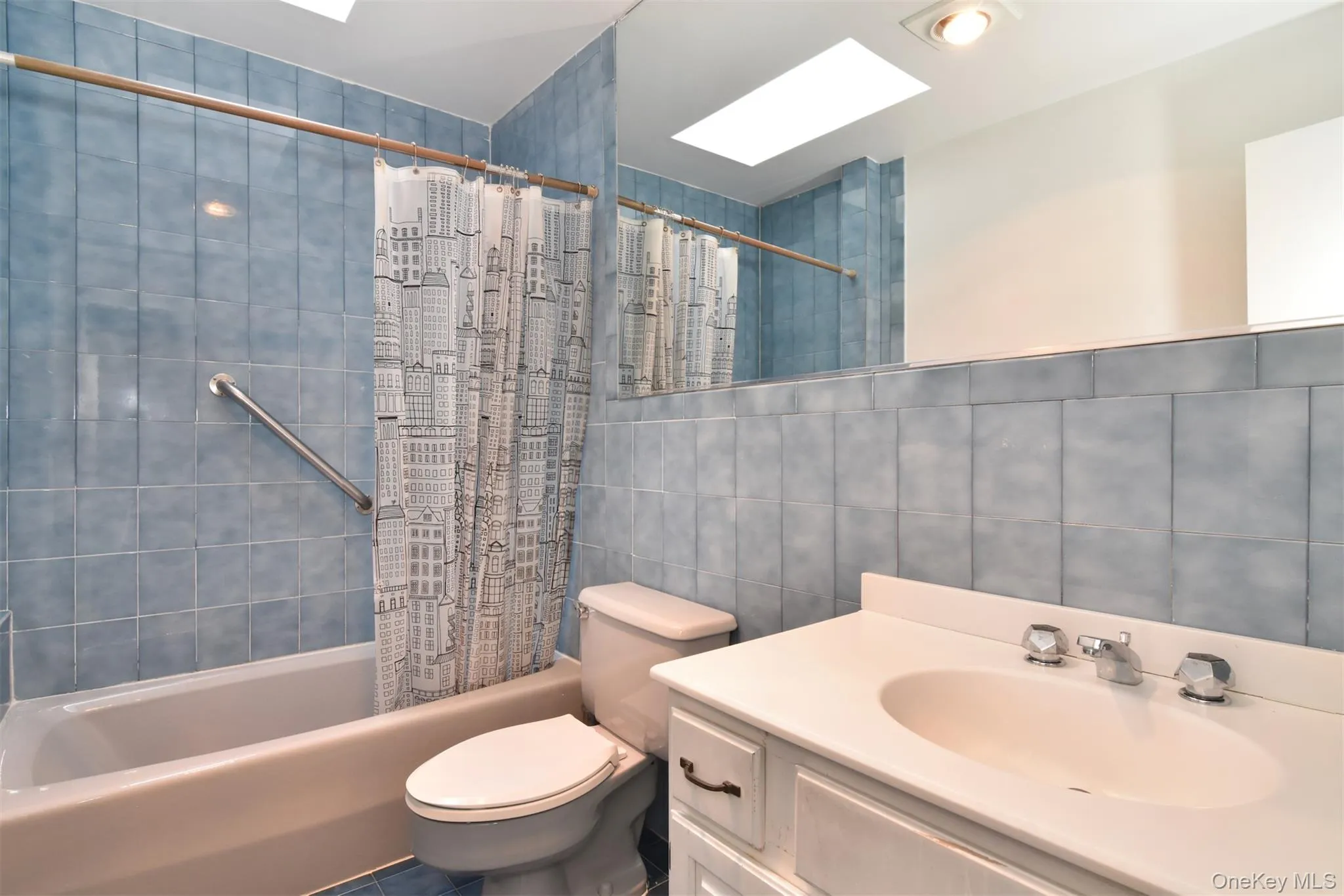 Skylit hall bathroom with vanity, shower and bathtub on second floor Skylit hall bathroom with vanity, shower and bathtub on second floor