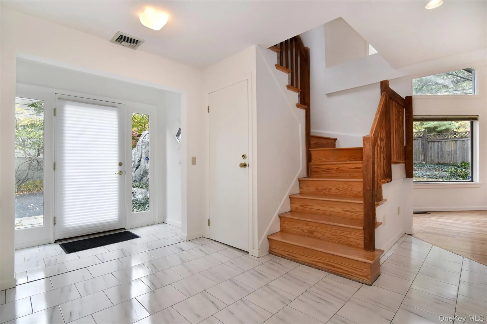 Light filled Foyer entrance with stairway and 2 closets Light filled Foyer entrance with stairway and 2 closets