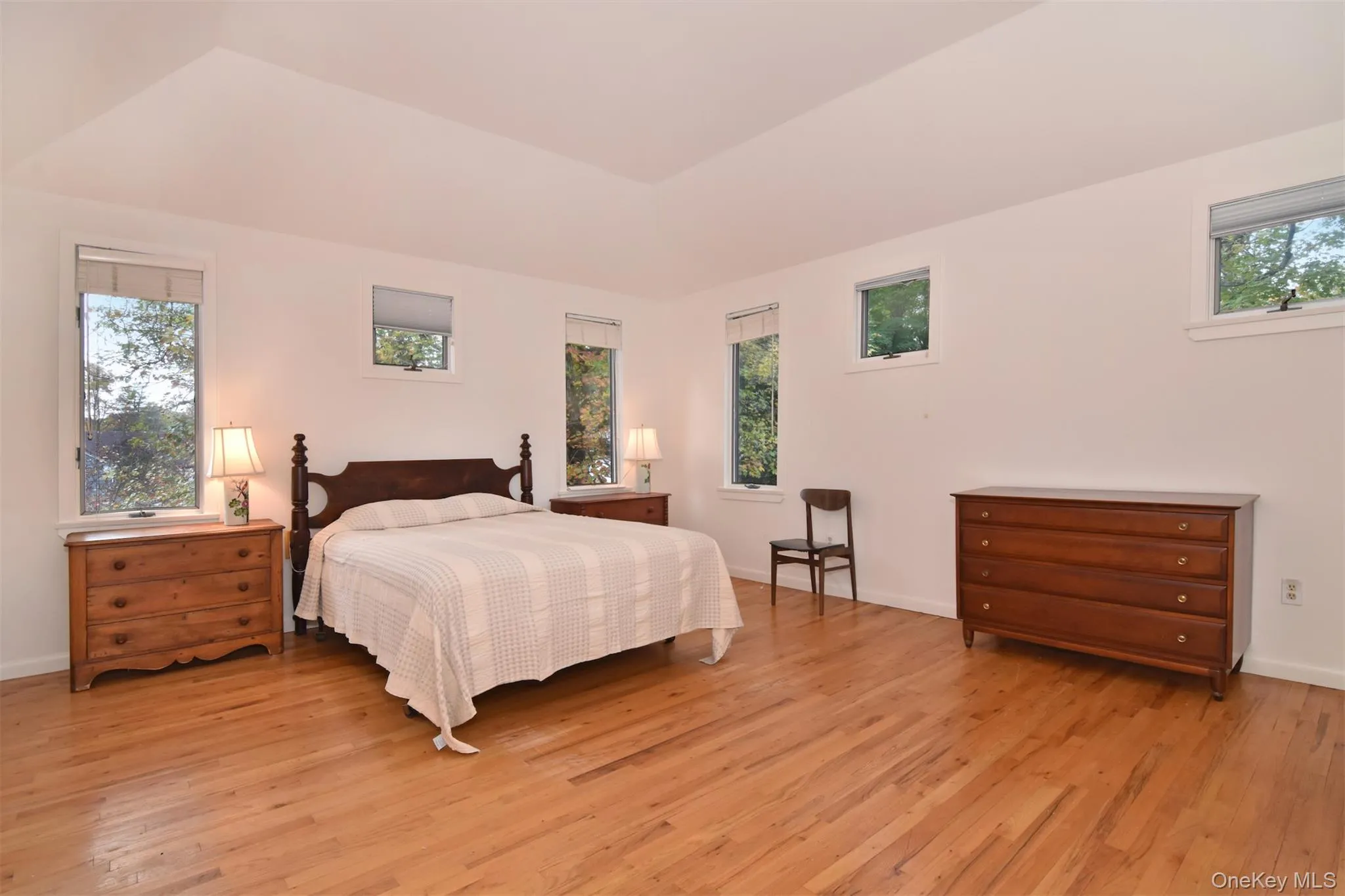 Bedroom featuring tray ceiling and 4 closets Bedroom featuring tray ceiling and 4 closets