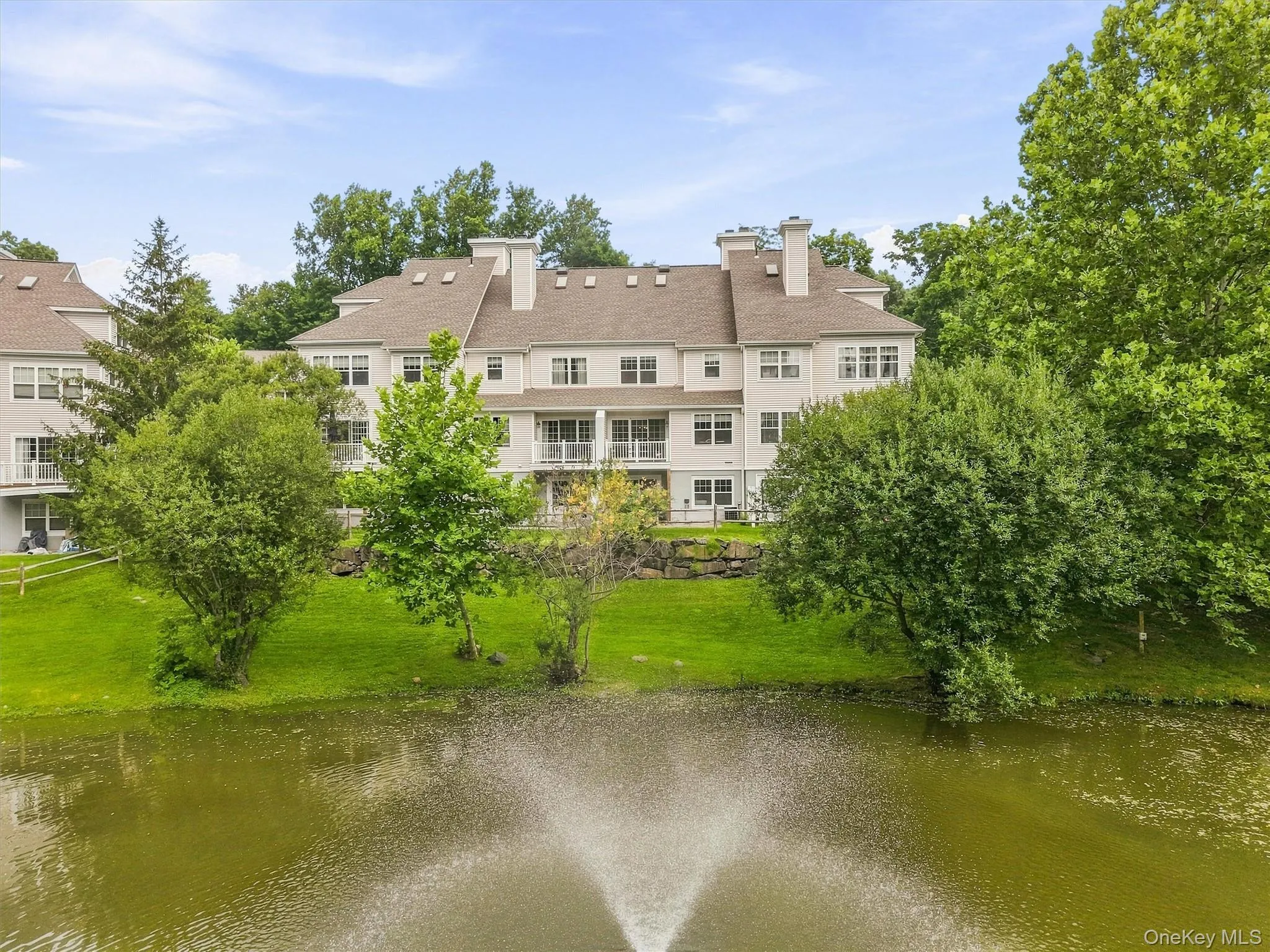 back of home featuring scenic, tranquil views overlooking the community pond back of home featuring scenic, tranquil views overlooking the community pond