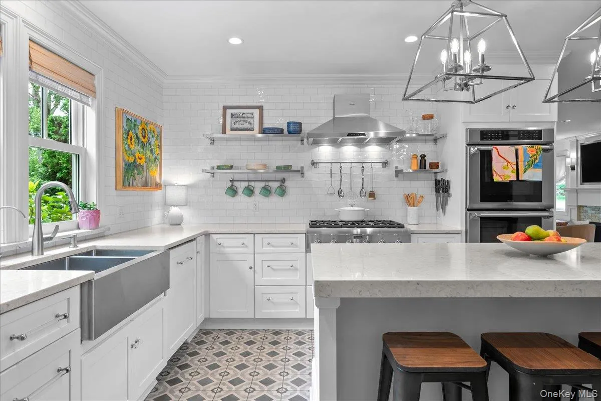 Stainless appliances include a stainless farmhouse style sink, Thermador cooktop, Thermador double ovens, microwave, and dishwasher. Stainless appliances include a stainless farmhouse style sink, Thermador cooktop, Thermador double ovens, microwave, and dishwasher.