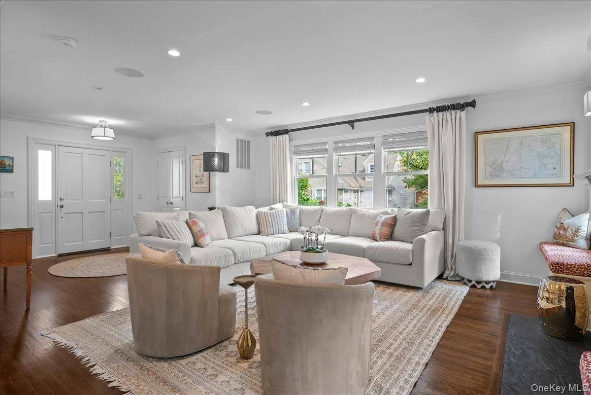 The large living room features lots of natural light, hardwood flooring, and custom window seats on either side of the fireplace. The large living room features lots of natural light, hardwood flooring, and custom window seats on either side of the fireplace.