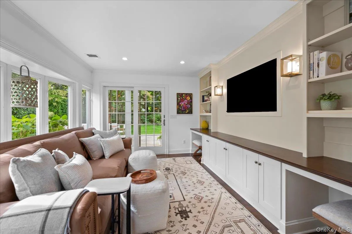 The cozy den features lovely built-ins, lots of natural light, and sliding french doors which open onto the back deck. The cozy den features lovely built-ins, lots of natural light, and sliding french doors which open onto the back deck.