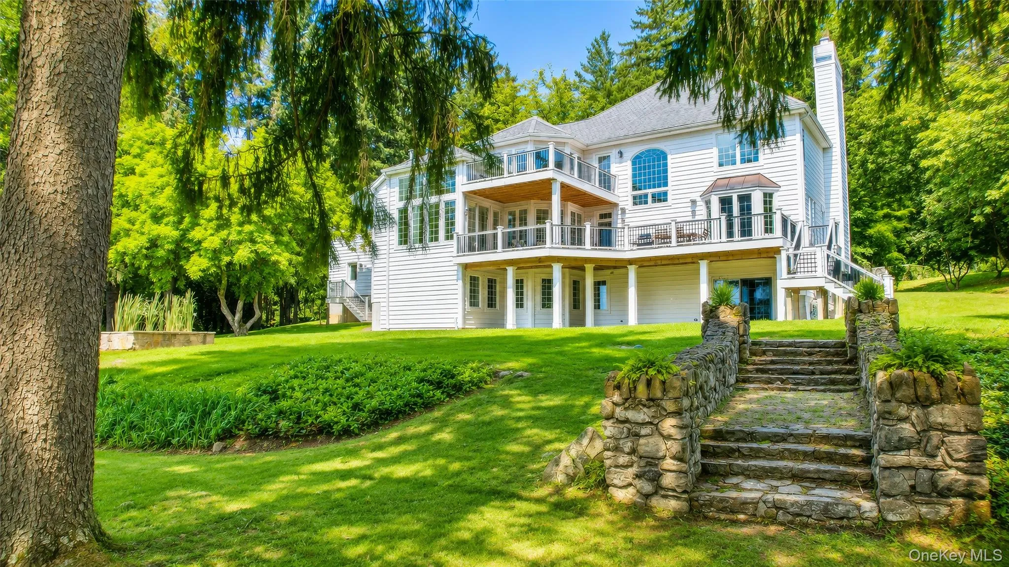 Meticulously landscaped, storybook grounds are framed by magnificent stone walls and meandering walkways that lead to a private outdoor sanctuary. Meticulously landscaped, storybook grounds are framed by magnificent stone walls and meandering walkways that lead to a private outdoor sanctuary.