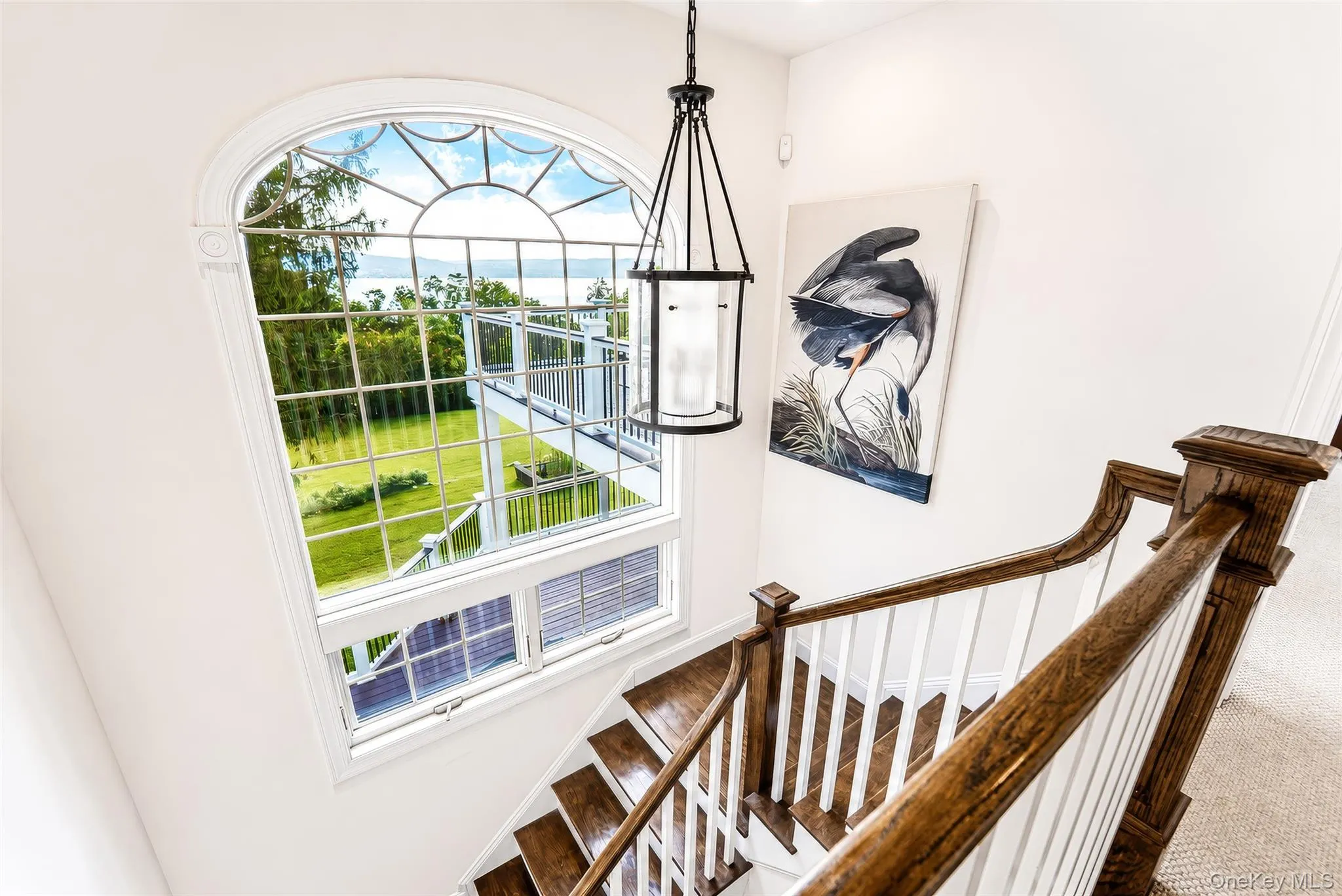 As you ascend to the upper level, a breathtaking window frames mesmerizing Hudson River views, while the beautifully crafted staircase showcases the timeless attention to detail found throughout Stonecrest Estate. As you ascend to the upper level, a breathtaking window frames mesmerizing Hudson River views, while the beautifully crafted staircase showcases the timeless attention to detail found throughout Stonecrest Estate.
