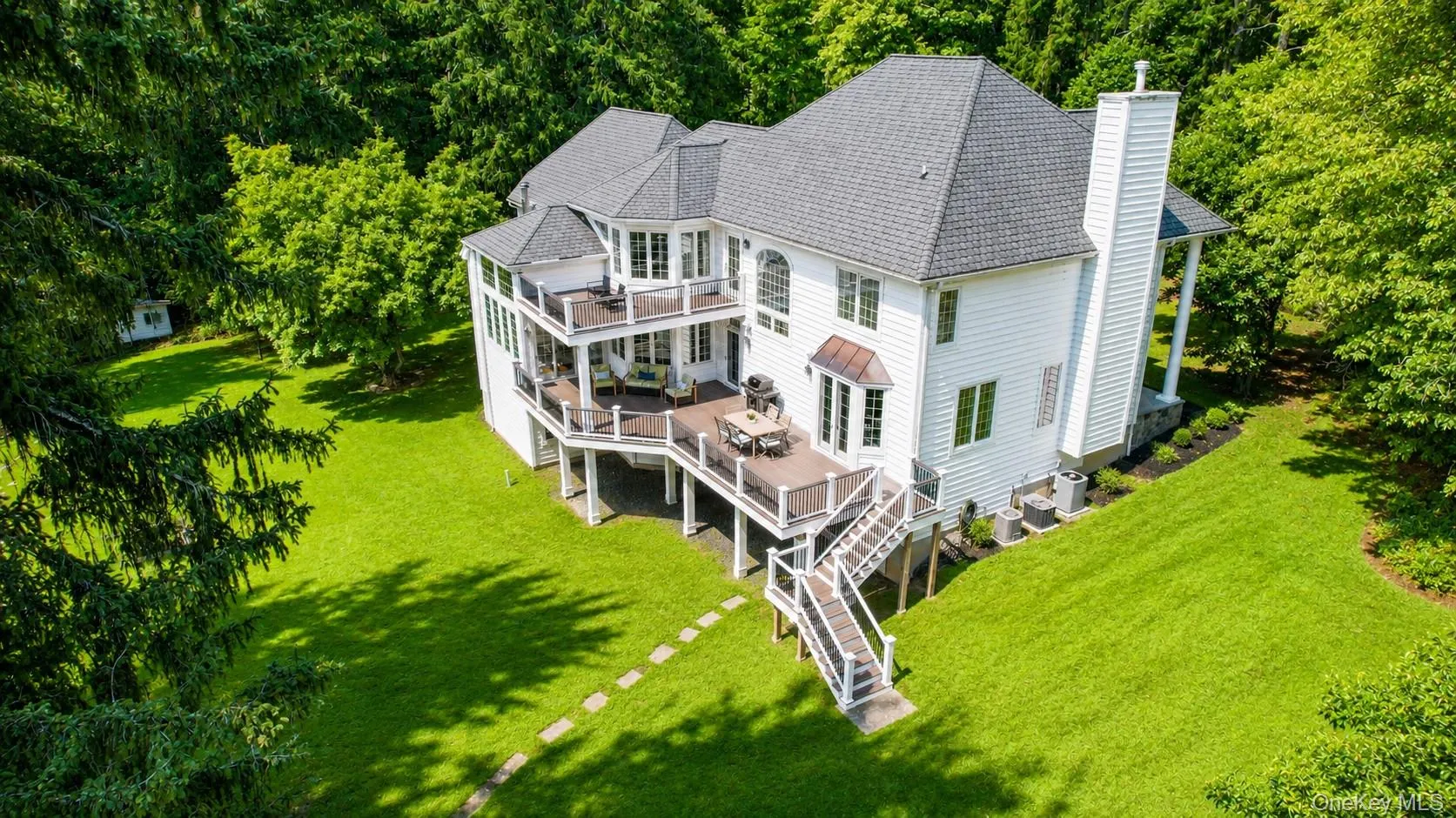 From above, Stonecrest Estate reveals its storybook charm, featuring an expansive entertaining deck, a private primary suite deck, and beautifully landscaped grounds that create an extraordinary outdoor retreat. From above, Stonecrest Estate reveals its storybook charm, featuring an expansive entertaining deck, a private primary suite deck, and beautifully landscaped grounds that create an extraordinary outdoor retreat.