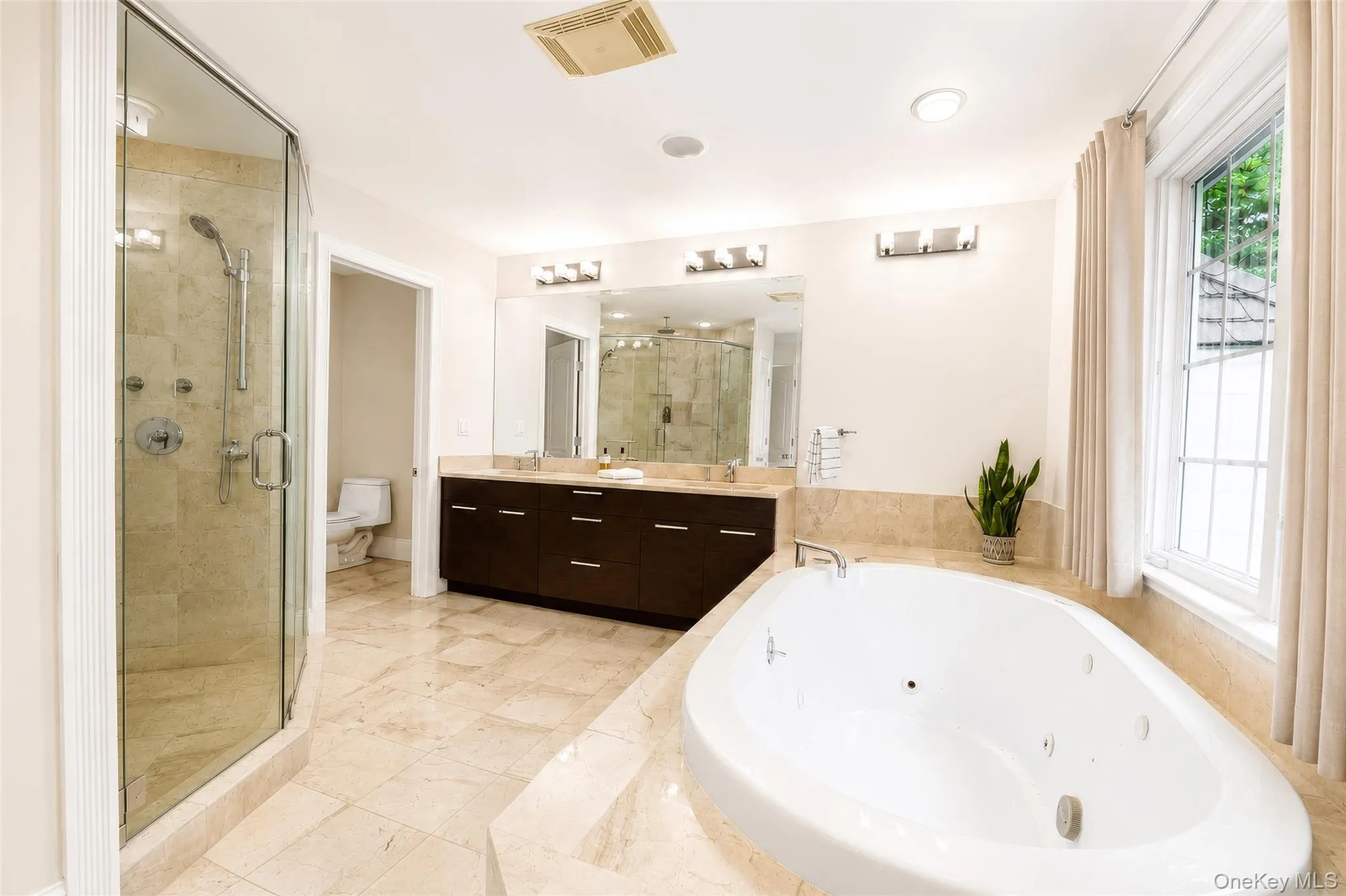 En-suite bath with jacuzzi soaking tub, double vanity and shower. En-suite bath with jacuzzi soaking tub, double vanity and shower.
