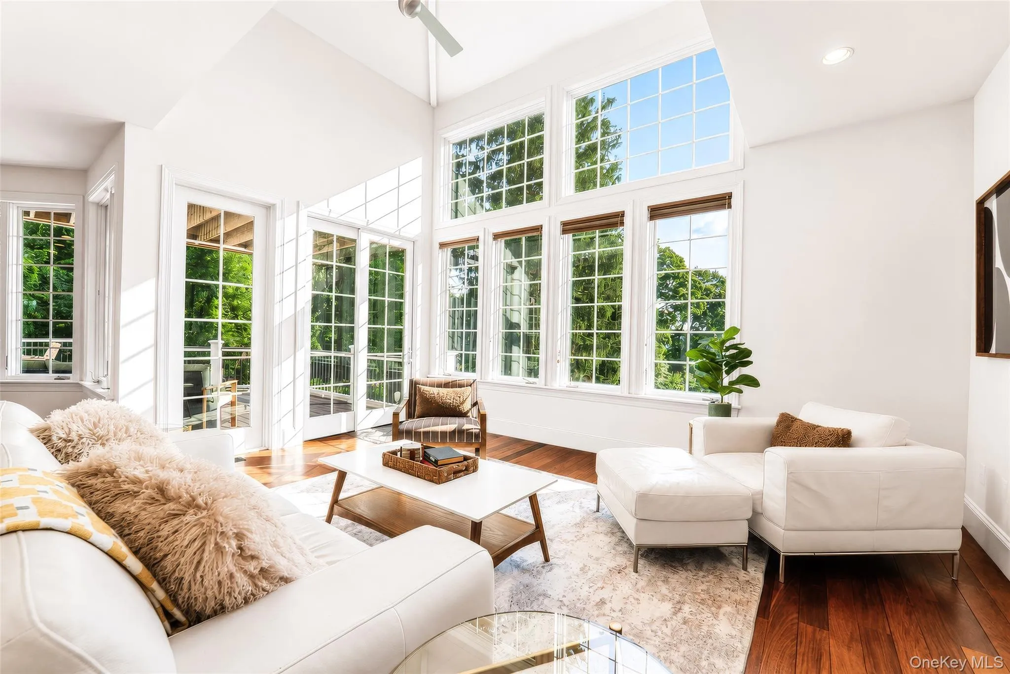 Soaring ceilings, a gas fireplace, and expansive walls of windows showcase uninterrupted year-round Hudson River views and unforgettable sunsets. Soaring ceilings, a gas fireplace, and expansive walls of windows showcase uninterrupted year-round Hudson River views and unforgettable sunsets.