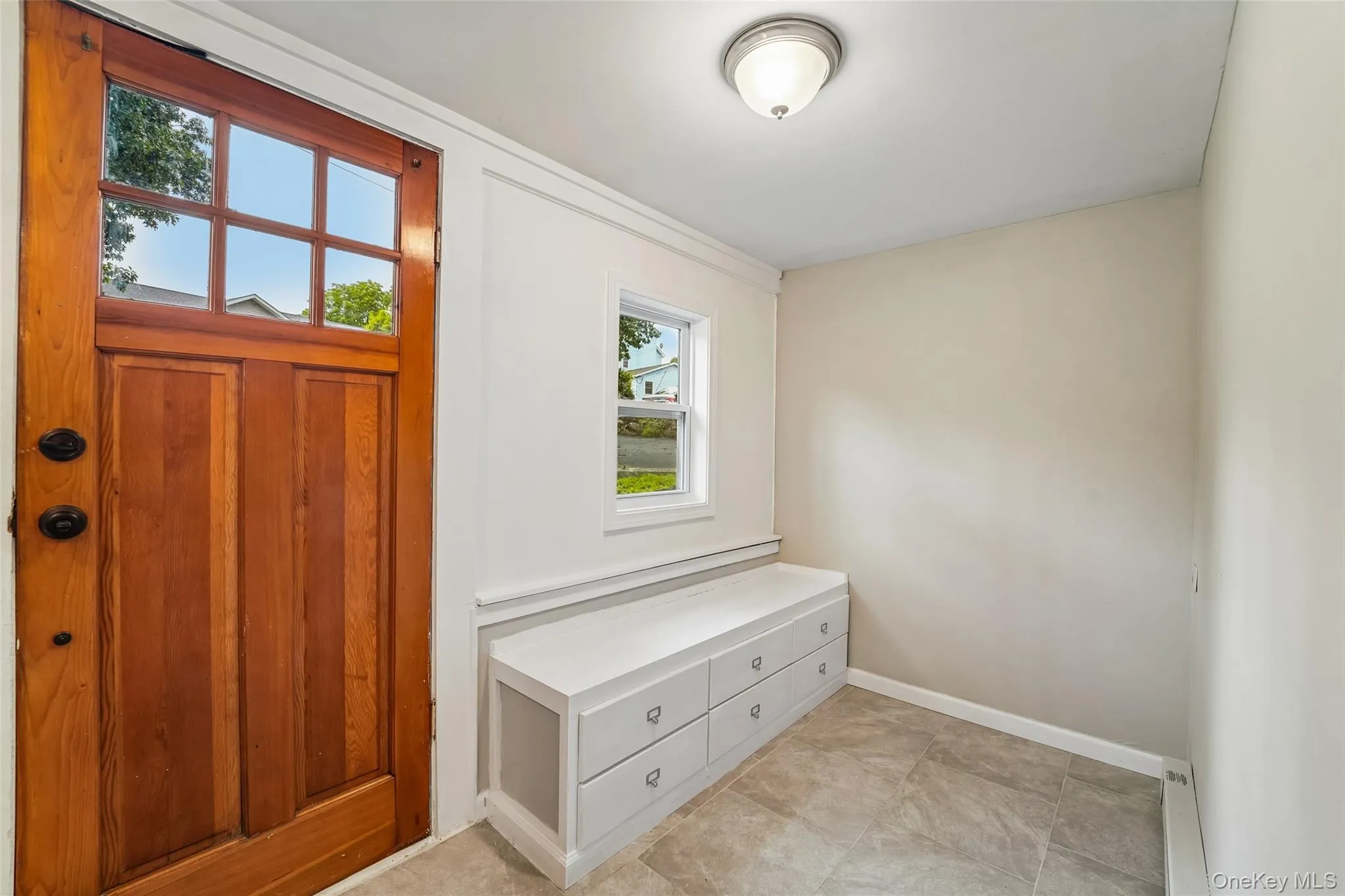 Entry foyer with bench storage. Entry foyer with bench storage.