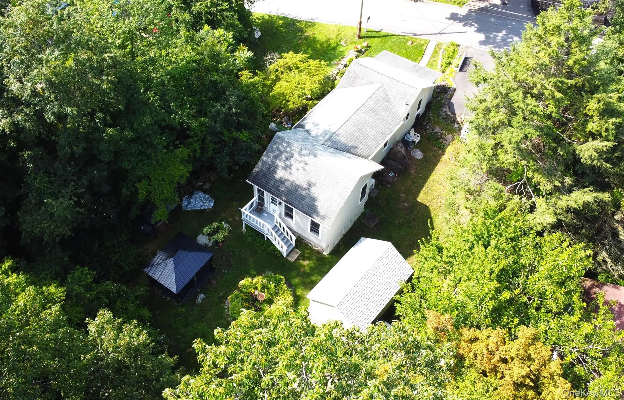 Aerial view of rear and west side of home. Aerial view of rear and west side of home.